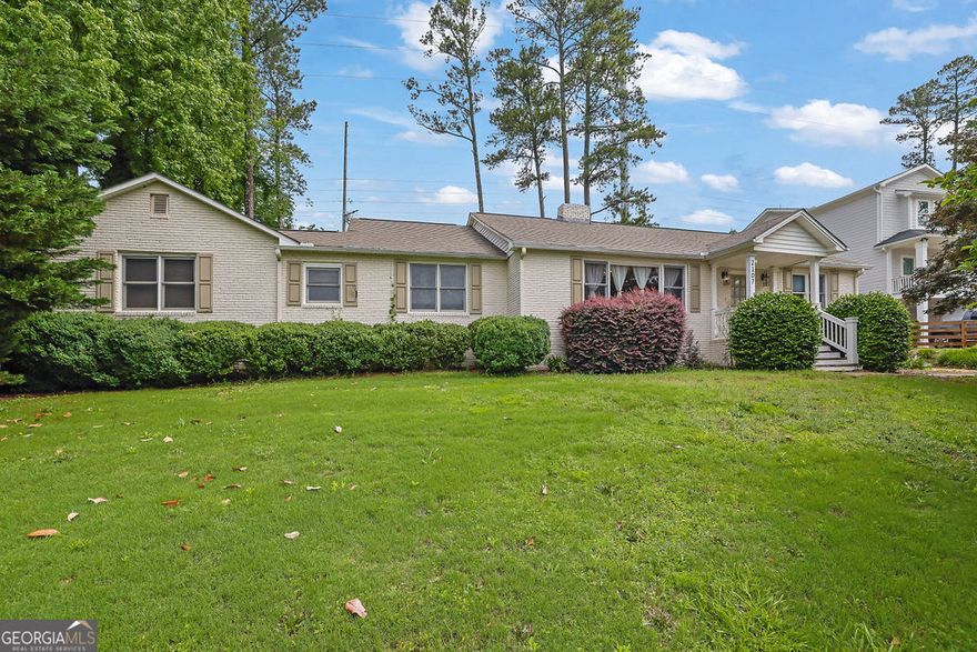Welcome home to this charming ranch-style brick residence, located in the highly sought-after Hillgrove High School district. Ideally located just 10 minutes from Marietta Square and less than 10 minutes from the shops and dining at West Cobb Avenues. This 3-bedroom, 2-bathroom home offers a perfect blend of comfort and functionality, including a very spacious bonus room complete with a cozy fireplace - perfect for a second living area, game room, media room, or home office.    As you step into the main living room, you're greeted by an inviting open space with a fireplace framed by built-in shelving. The open kitchen features a central island that doubles as a breakfast bar. The kitchen comes equipped with a gas stovetop, oven, refrigerator, and microwave.    The adjacent dining area provides direct access to the fenced-in backyard. The backyard has a large patio and fire pit, perfect for entertainment. Both bathrooms have been updated, and beautiful hardwood floors flow throughout the living room and all three bedrooms, adding warmth and charm.    Additional features include a garage with electricity, offering extra storage or workspace. Don't miss this move-in-ready gem in a prime location-schedule a showing today!