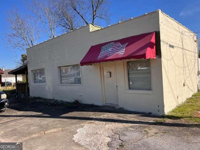Seize the opportunity to own a commercial building in the heart of Griffin's revitalized downtown, just steps away from popular shops and trendy restaurants. This versatile space is perfect for entrepreneurs looking to establish a new venture or expand an existing one. Whether you're envisioning a cozy cafe, boutique, or professional office, this property offers the flexibility to shape the space into something uniquely yours. This space features two separate bathrooms and an attached, covered deck for additional charm. THREE ADJACENT LOTS, LOCATED NEXT TO AND BEHIND THE BUILDING, ARE NOW INCLUDED IN THIS SALE PRICE! The original list price was for the building and lot only. Now all four lots with the building are combined for high visibility and easy access at a great price. Don't miss the chance to invest in this unique property and become part of Griffin's growing business landscape. Contact your favorite agent today to explore the potential of this exceptional space!