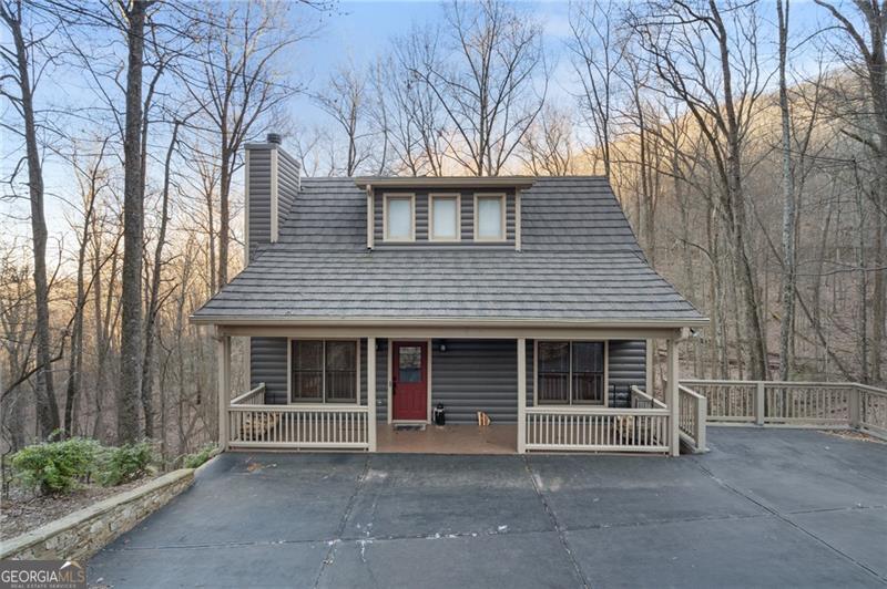 Beautifully maintained cozy log cabin with 3 BR & 3 Bath design backs to year round creek with seasonal mountain views. One bedroom with full bath access located on each of the 3 levels, with hardwood flooring on the main. Open floorplan features dramatic high volume vaulted T&G wood ceiling and stacked stone fireplace in the great room with kitchen, dining area and laundry room nearby for easy access. Bedroom suite located upstairs enjoys a loft overlooking the main level that makes for an ideal reading room or home office. The terrace level offers a bedroom suite and family room with interior and outside access. Recent improvements include adding a premium 40+ year roof with long lasting metal shingles similar to what was used at the BC Clubhouse. The asphalt driveway was replaced with poured concrete and the PT retaining wall was removed and upgraded with stacked stone with this project completed by Ben Hopkins. All kitchen appliances and water heater were replaced, exterior was recently repainted including the majority of interior walls. Screen porch with T&G wood ceiling was added, expansive covered front porch deck with zero entry, and the flat concrete driveway makes for easy ingress and egress. This is an absolute gem of a property and a must see. Home can be sold turnkey!