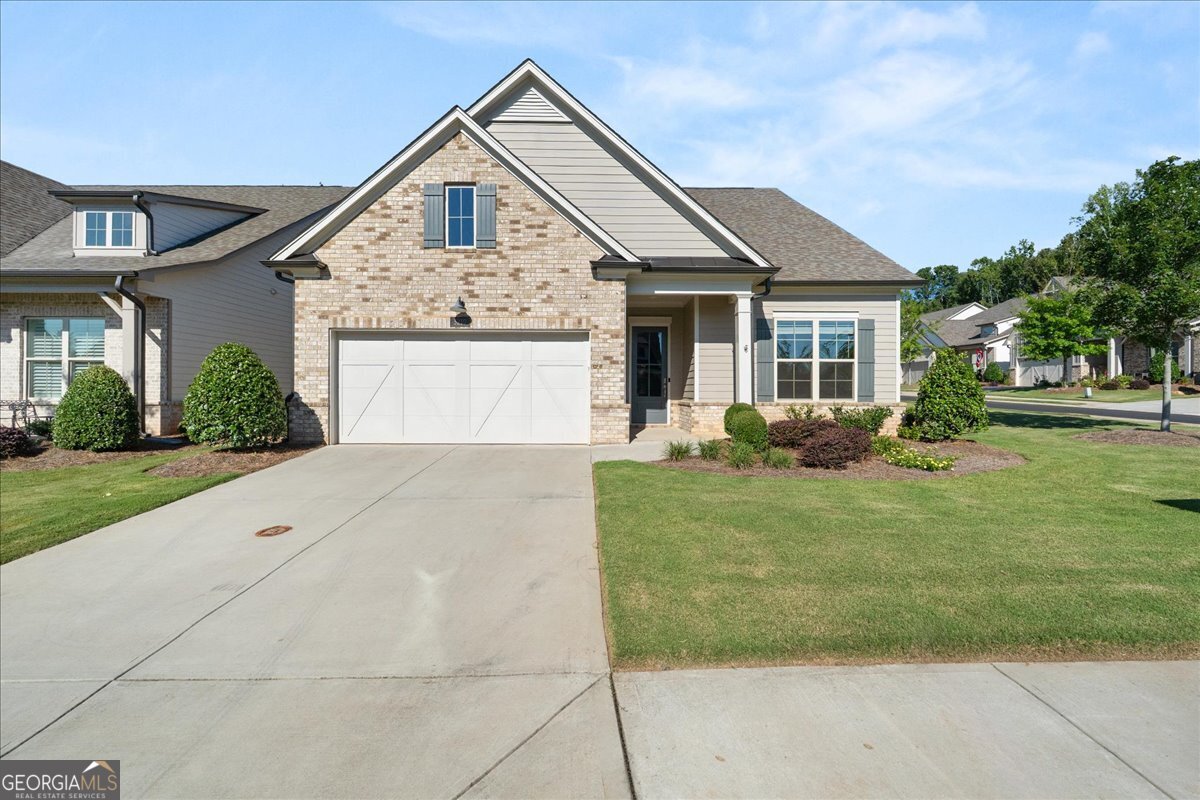 Welcome to this beautiful stand-alone home in the highly sought-after gated 55+ community of Traditions at Herrington. Built in 2021 and set on a spacious corner lot, this single-level residence offers 3 bedrooms, 2 bathrooms, and an inviting open-concept layout with soaring 10-foot ceilings. A versatile bonus room provides the perfect space for a home office, hobby room, or creative studio. The kitchen features sleek stainless steel appliances and a design ideal for gathering with family and friends. Step outside to the screened-in porch to enjoy your morning coffee or unwind with an evening meal in the fresh air. Community amenities include a stunning clubhouse with a large pool, fitness center, game room and lounge, as well as a pet park and scenic walking trail. Conveniently located just minutes from shopping, dining, and Northside Hospital, this home offers the perfect blend of comfort, convenience, and active adult living.