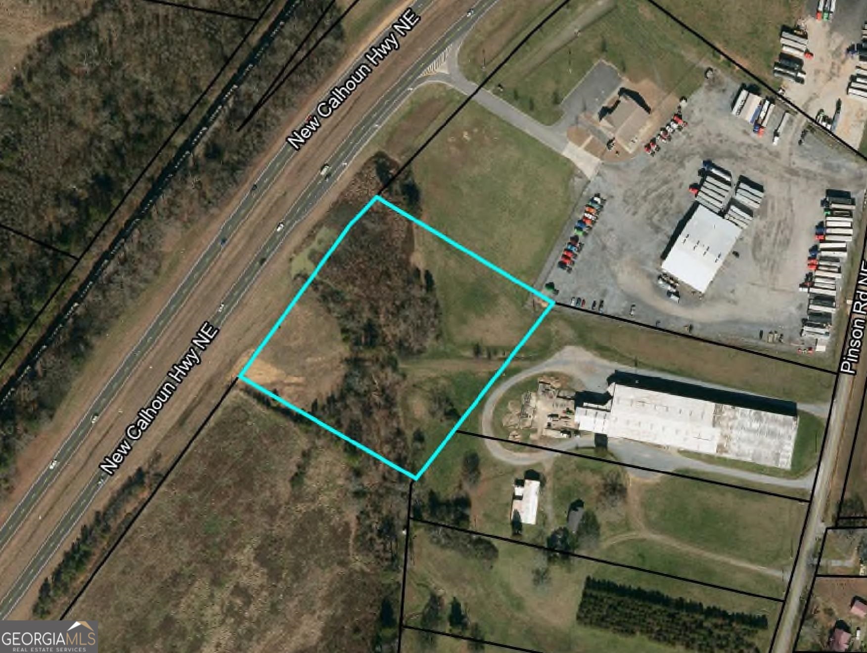 4.19 acre Light Industrial tract located on Hwy 53 . Approximately 1.5 miles from Hwy 140 and only 10 miles from I-75. Approximately 450' of road frontage on Hwy 53. 17,800 traffic count daily. Buyer to verify zoning and utilities.