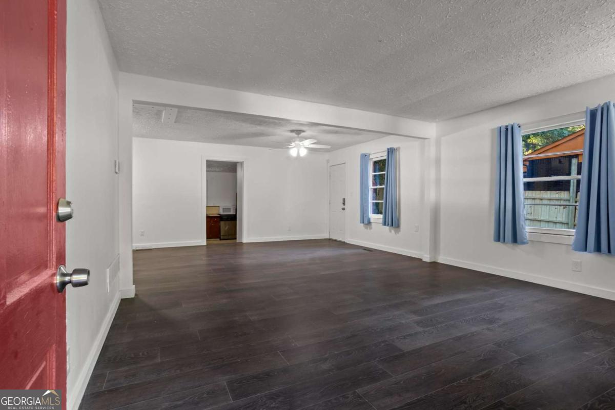 Welcome home to this move-in ready 4 bedroom, 2 bathroom gem! Where else can you find this sqft for the price? Step inside and you'll immediately notice the fresh interior paint and new flooring that flows throughout the main living and bedroom areas. Enjoy a large open-concept living space, perfect for entertaining. Three bedrooms share a recently renovated hall bathroom, while the expansive primary suite addition at the back of the home offers the privacy and comfort you've been looking for. The spacious kitchen is designed for both function and style, complete with a pantry, stainless steel appliances, and TWO refrigerators-ideal for meal prep, entertaining, or extra storage. Additional features include: security system & Ring doorbell for peace of mind, newer washer & dryer, main sewer line replaced in 2023.