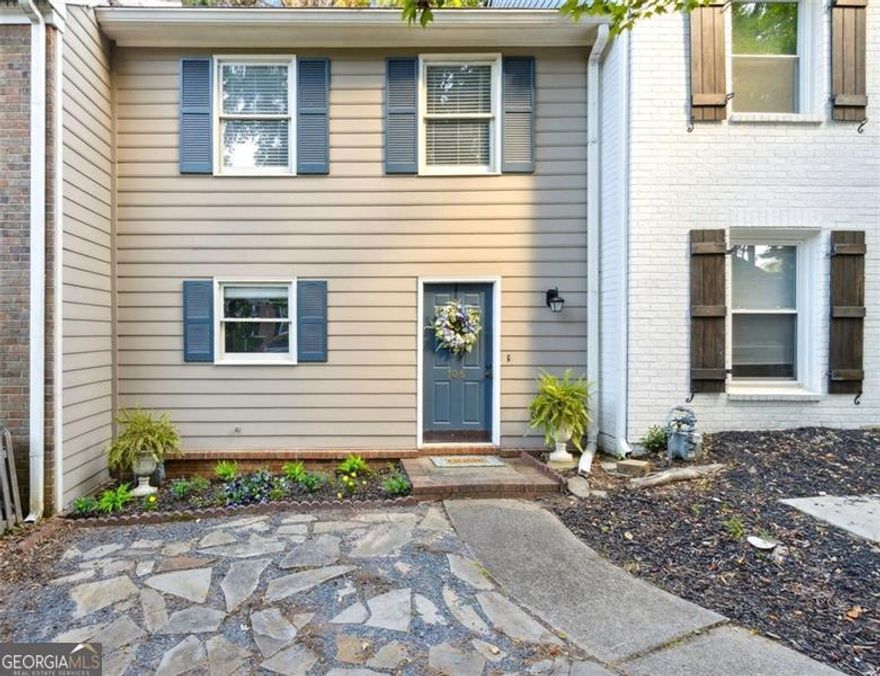 Smart Move-For Nesters, Investors, and Everyone in Between! Now newly refreshed in price, this Marietta townhome delivers comfort, convenience, and value in one perfect package. The bright kitchen with breakfast nook flows into a separate dining area and a fireside living room featuring a charming brick fireplace-perfect for cozy evenings. Step out to a private deck framed by wooded views ideal for relaxing or grilling. Upstairs, two oversized bedrooms each feature ensuite baths, offering flexibility for guests, roommates, or a home office. All appliances remain, including the upstairs laundry, for an easy move-in. With no rental restrictions and a voluntary HOA, this home is ideal for homeowners or investors. Located minutes from I-75, Marietta Square, Truist Park, KSU, shopping, and dining-this refreshed opportunity defines Marietta living at its best.