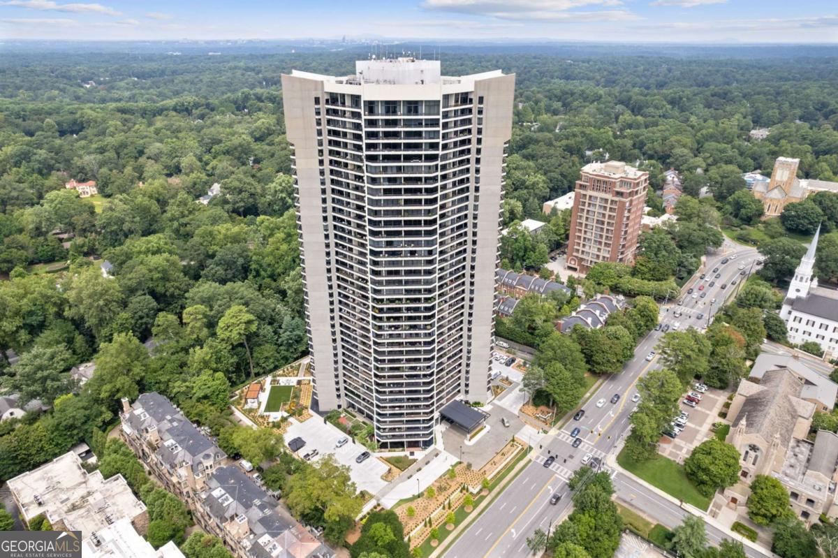 Live where legends have lived - this Buckhead luxury condo has star power. Welcome to this stunning 2-bedroom, 2-bathroom condo in one of Buckhead's most iconic high-rises - the very building where music legend Elton John once called home. Perfectly situated in the heart of Atlanta's most prestigious neighborhood, this residence offers an unmatched blend of style, sophistication, and history. Step inside to find floor-to-ceiling windows that flood the space with natural light and showcase sweeping city views - you can see from downtown Atlanta, Stone Mountain and all of Buckhead. The wonderful layout features a sleek modern kitchen with high-end appliances, quartz countertops, and a spacious pantry. The primary suite is a private retreat with a spa-inspired bath, custom walk-in closet, and access to a private balcony. Additional highlights include hardwood floors, a second full bedroom and bath ideal for guests or a home office, and assigned parking space as well as valet service. This full-service building recently underwent a $30M renovation and offers top-tier amenities including 24-hour concierge, valet, gated secured parking garage, traffic light for easy ingress and egress, event room with full catering kitchen available for homeowner use, heated saltwater pool with newly expanded pool deck and shade features, new beautiful garden with event lawn, water and fire features and grill pavilion with dining area, fitness center with sauna, climate controlled wine cellar where each homeowner has an assigned bin, 2 guest suites available for owners to rent for their guests, convenient pet walk, community EV charging stations, emergency call system and water leak detection system in every home, many social activities, and assigned storage with every home. All just steps away from Buckhead's premier dining, shopping, and cultural attractions. Whether you're a luxury lover, city dweller, or music history buff - this is your chance to live like a legend.