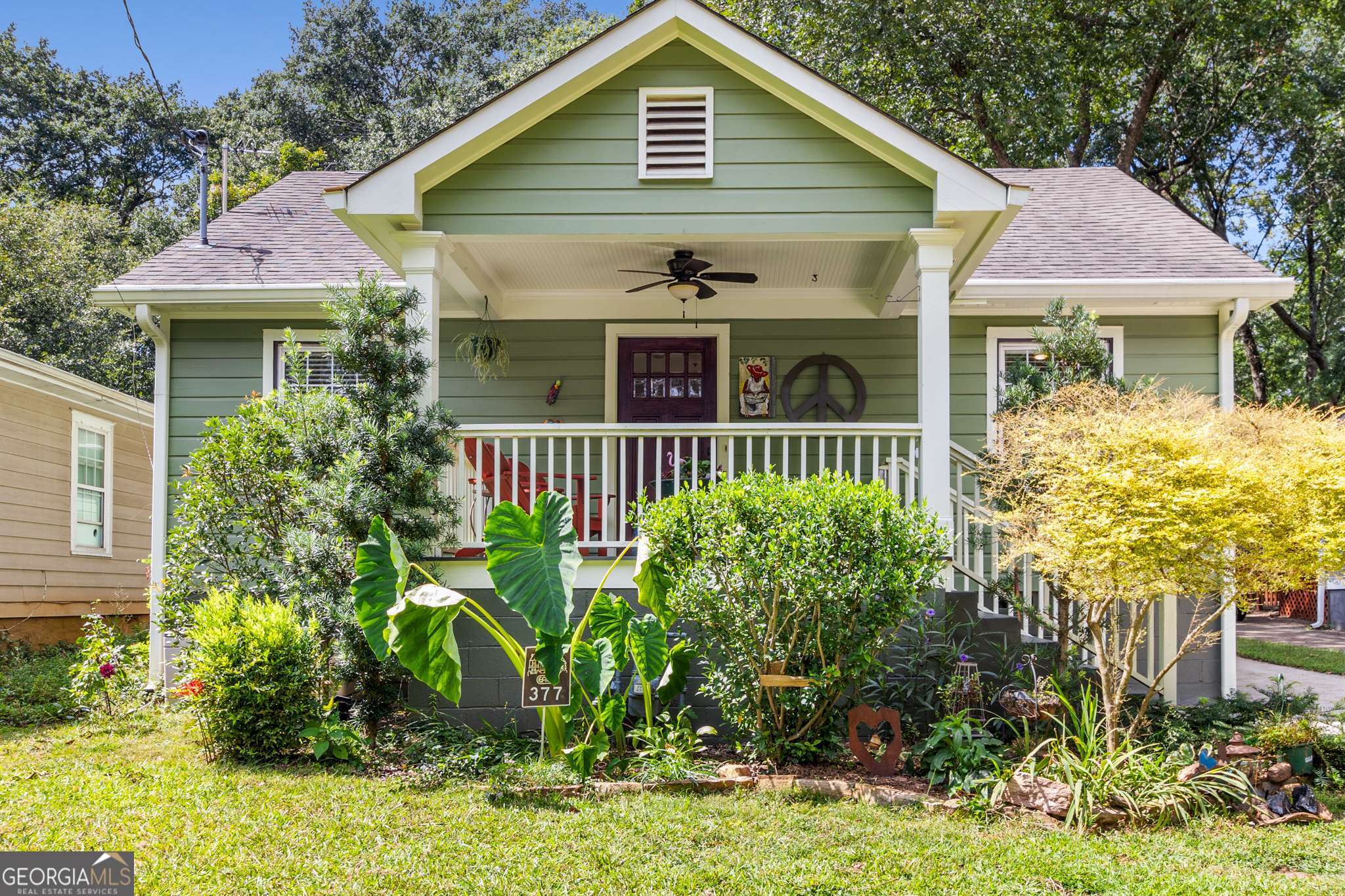 This classic East Atlanta bungalow blends historic character with modern updates, offering 3 bedrooms, 2 full baths, and hardwood floors throughout. The inviting front porch sets the tone-perfect for relaxing and connecting with neighbors. Inside, the living room flows seamlessly into the dining area, while the kitchen opens to a comfortable family room, creating an ideal layout for both entertaining and everyday living. The kitchen showcases natural wood shaker-style cabinetry, granite countertops, a peninsula with counter seating, stainless steel appliances, a gas range, and a pantry for extra storage. The spacious primary suite includes a walk-in closet and a beautifully updated bath featuring a double vanity and a large walk-in shower with a semi-frameless glass enclosure. Step outside to enjoy a deck overlooking the walk-out, flat backyard-an ideal setting for gatherings. The fenced yard offers a charming storage shed (or potential studio), a majestic Japanese maple, and a cozy fire pit. Located just a short walk from East Atlanta Village's popular restaurants, bars, and nightlife, as well as Brownwood Park with tennis and basketball courts, this home offers the perfect mix of charm, convenience, and community.