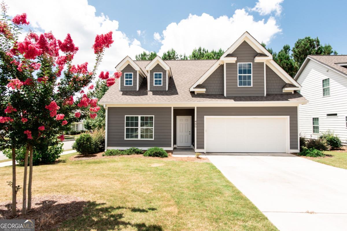 Great west Athens home convenient to UGA, shopping and restaurants. Freshly painted with updated finishes like quartz countertops, subway backsplash and LVP floors, you'll love the open plan living and primary suite on the main level plus a shady covered back porch. There's also a half bath and laundry (all appliances remain!). Upstairs are two large bedrooms, a hall bath and an area for an office or play area. You won't lack for storage space with large walk in closets in each bedroom. Rare at this price point, you also get a true two car garage. The reasonable HOA covers yard service and trash and maintains a lovely playground and park in this sidewalk community. Easy to show!