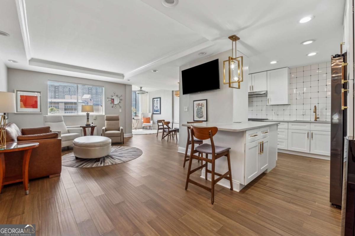 MOTIVATED SELLER!! Welcome to Landmark, an investor's dream in Downtown Atlanta. This FULLY renovated 2-bedroom, 2-bathroom condo is conveniently located right off 75/85, and an easy 10 minute walk to the MARTA station that will take you straight to StateFarm Arena, Mercedes Benz Stadium, the World Congress Center, Georgia Aquarium, Tabernacle, The Georgia Capitol, and everything else Downtown has to offer. With NO RENT RESTRICTIONS, enjoy the flexibility of short or long-term leasing. Experience the ease of an HOA that covers electricity, internet, gas, water, trash, pest/termite control, all exterior and common area maintenance, the pool, and concierge staff. Rest easy knowing the building is secured by the latest technology, allowing you to provide guests with QR code access that includes customizable expiration dates using the ButterflyMX intercom system. Take advantage of the opportunity to own this unicorn condo before the FIFA World Cup comes to town in 2026, the Superbowl in 2028, or the laundry list of events that take place here every single year: Dragon Con, Momo Con, Music Midtown, Shaky Knees, Atlanta Pride, ONE Music Fest, Sweetwater 420 Fest, the Dogwood Festival, NYE Peach Drop, Peachtree Road Race, the St. Patrick's Day Parade, and SO much more. Not only is the location incredible, but the condo itself has been painstakingly updated by an owner-occupant, which means you don't have to deal with the hassle of coordinating contractors, elevators, material drop offs, etc. What it DOES mean is that you get to enjoy a high-quality & thoughtfully designed layout that includes a stunning kitchen with high-end appliances, a touch2O faucet, a wine cooler, a built-in water purifier with a Keurig attachment, recessed lighting, luxury vinyl flooring, all new cabinetry, an LED mirror in the master, tiled baths, and a built-in supplemental AC unit. You see this building in the skyline from the Jackson Street Bridge all the time, come see it in person too!