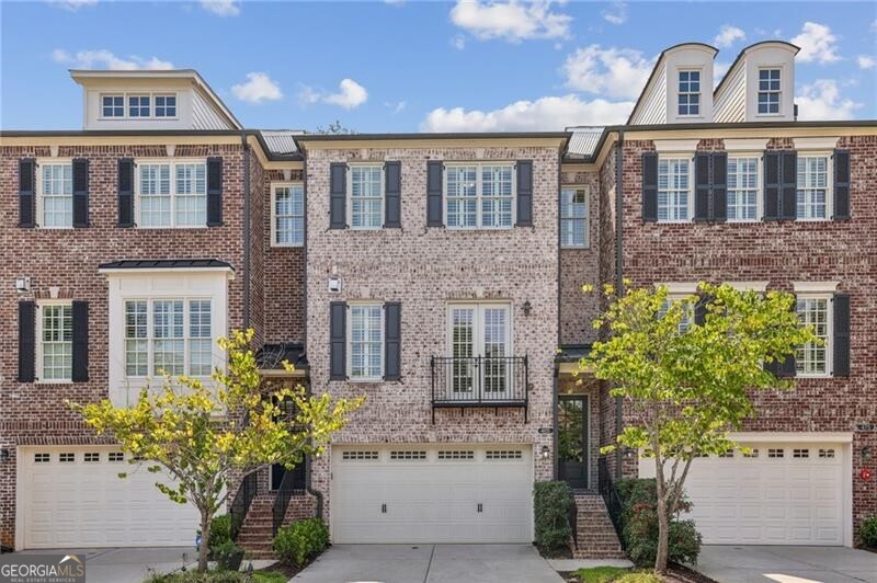 **Discover Your Dream Home in the Heart of the Garden District!** Welcome to the coveted Downtown Alpharetta, where this stunning brick townhome awaits you. Just steps away from an exciting mix of shops, restaurants, parks, and entertainment, this residence offers the perfect blend of comfort and convenience. Step inside to a light-filled, open-concept main floor that seamlessly integrates a spacious family room, featuring a custom fireplace, with a chic dining area adorned with modern lighting. The elegant white kitchen boasts luxurious marble countertops and stainless steel appliances, making it a chef's delight. A thoughtfully designed laundry room with custom shelving and a convenient half bath are located just off the kitchen. Retreat to your private outdoor oasis on the covered, heated deck-an ideal spot for relaxation and entertainment, complete with a TV for your enjoyment, all set amidst nature's beauty. Upstairs, the expansive primary suite is your personal sanctuary, showcasing exquisite white marble countertops, double sinks, and an oversized frameless shower with dual heads. A custom walk-in closet provides abundant storage. Down the hall, a spacious secondary en-suite bedroom with another walk-in closet offers privacy and comfort for guests or family. The versatile terrace level features a full bath and a flexible space perfect for an office, extra bedroom, or home gym, along with three custom storage closets. Enjoy the tranquility of a second heated, covered deck, surrounded by mature landscaping for an additional retreat. Parking is a breeze with a two-car garage and an accommodating driveway for two more vehicles, ensuring plenty of space for guests beautifully finished with an epoxy floor coat. Additional highlights include plantation shutters, hardwood flooring throughout, a Ring doorbell for added security, elevator readiness, and smart Wi-Fi thermostats for modern convenience. This exquisite home is move-in ready and poised for a quick closing. Don't miss your chance to live in this vibrant community-schedule your visit today!