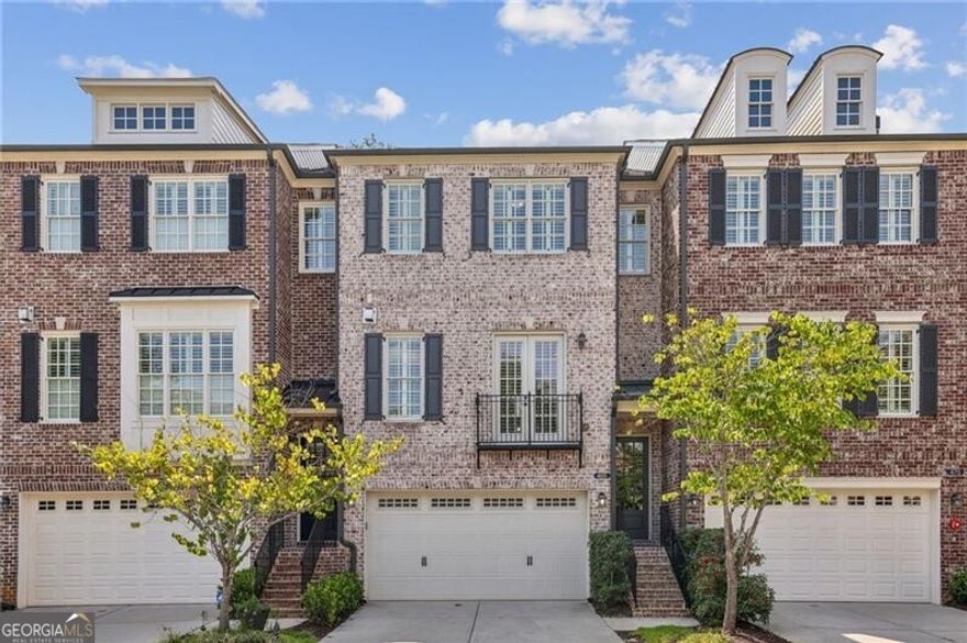 **Discover Your Dream Home in the Heart of the Garden District!**  Welcome to the coveted Downtown Alpharetta, where this stunning brick townhome awaits you. Just steps away from an exciting mix of shops, restaurants, parks, and entertainment, this residence offers the perfect blend of comfort and convenience.  Step inside to a light-filled, open-concept main floor that seamlessly integrates a spacious family room, featuring a custom fireplace, with a chic dining area adorned with modern lighting. The elegant white kitchen boasts luxurious marble countertops and stainless steel appliances, making it a chef's delight. A thoughtfully designed laundry room with custom shelving and a convenient half bath are located just off the kitchen.  Retreat to your private outdoor oasis on the covered, heated deck-an ideal spot for relaxation and entertainment, complete with a TV for your enjoyment, all set amidst nature's beauty.   Upstairs, the expansive primary suite is your personal sanctuary, showcasing exquisite white marble countertops, double sinks, and an oversized frameless shower with dual heads. A custom walk-in closet provides abundant storage. Down the hall, a spacious secondary en-suite bedroom with another walk-in closet offers privacy and comfort for guests or family.  The versatile terrace level features a full bath and a flexible space perfect for an office, extra bedroom, or home gym, along with three custom storage closets. Enjoy the tranquility of a second heated, covered deck, surrounded by mature landscaping for an additional retreat.  Parking is a breeze with a two-car garage and an accommodating driveway for two more vehicles, ensuring plenty of space for guests beautifully finished with an epoxy floor coat. Additional highlights include plantation shutters, hardwood flooring throughout, a Ring doorbell for added security, elevator readiness, and smart Wi-Fi thermostats for modern convenience.  This exquisite home is move-in ready and poised for a quick closing. Don't miss your chance to live in this vibrant community-schedule your visit today!