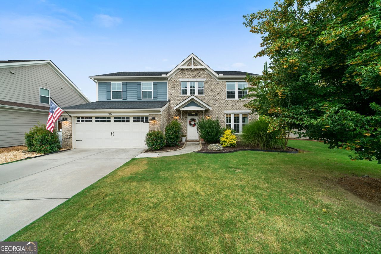 Step into the warmth and charm of this meticulously maintained home, cared for by its original owners and offering thoughtful upgrades and design throughout. Nestled in one of the area's most desirable communities, this residence blends timeless elegance with modern convenience - better than new construction and move-in ready for your next chapter. From the moment you walk in, you are greeted by rich engineered wood floors that flow through the main level, setting the tone for the home's welcoming and refined atmosphere. A dedicated formal dining room invites gatherings. A conveniently located powder room ensures comfort for visitors. The bedroom on the main floor with its own private ensuite bathroom offers flexibility and multi-generation living opportunities. The heart of the home lies in its open-concept living space - where the cozy fireplace anchors the family room, seamlessly connecting to a spacious, sun-filled chef's kitchen complete with upgraded lighting, a breakfast nook, a kitchen island and views of the beautifully landscaped, fenced-in backyard. Enjoy morning coffee or evening dinners on the covered patio, a peaceful retreat designed for relaxation and entertaining. Upstairs, you'll find four generously sized bedrooms, each featuring large walk-in closets to meet all your storage needs. The oversized primary suite is a true sanctuary, with room to unwind, a luxurious bath with separate shower and soaking tub, and a massive walk-in closet. A shared full bathroom with a private water room adds functionality and comfort. Lastly, the huge Mud/Laundry Room is conveniently located on the upper floor and is complete with a utility sink, its own closet and attic access. The two-car garage boasts coated floors and plenty of room for a workstation or extra storage. Located in a vibrant community with resort-style amenities including a pool, tennis courts, playground, and fitness center, you'll also love the top-rated schools and the unbeatable convenience to the shopping, dining, and entertainment of Dallas, Acworth, and Kennesaw. Don't miss the chance to call 307 Floating Leaf Way your forever home - where every detail tells a story of comfort, quality, and care.