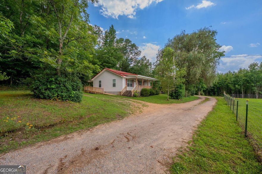 Welcome to 105 Dodson Shields Road in LaFayette, GA! This charming 2 bedroom, 1 bathroom home is nestled on a peaceful, wooded lot and features a welcoming front porch with a wheelchair-accessible ramp, offering added convenience and ease of entry. Inside, you'll find an open living and kitchen area with updated flooring, neutral colors, and great natural light. The spacious kitchen includes ample cabinet and counter space-perfect for daily living or entertaining. Enjoy the quiet outdoors in the spacious yard surrounded by mature trees, offering privacy and relaxation.
