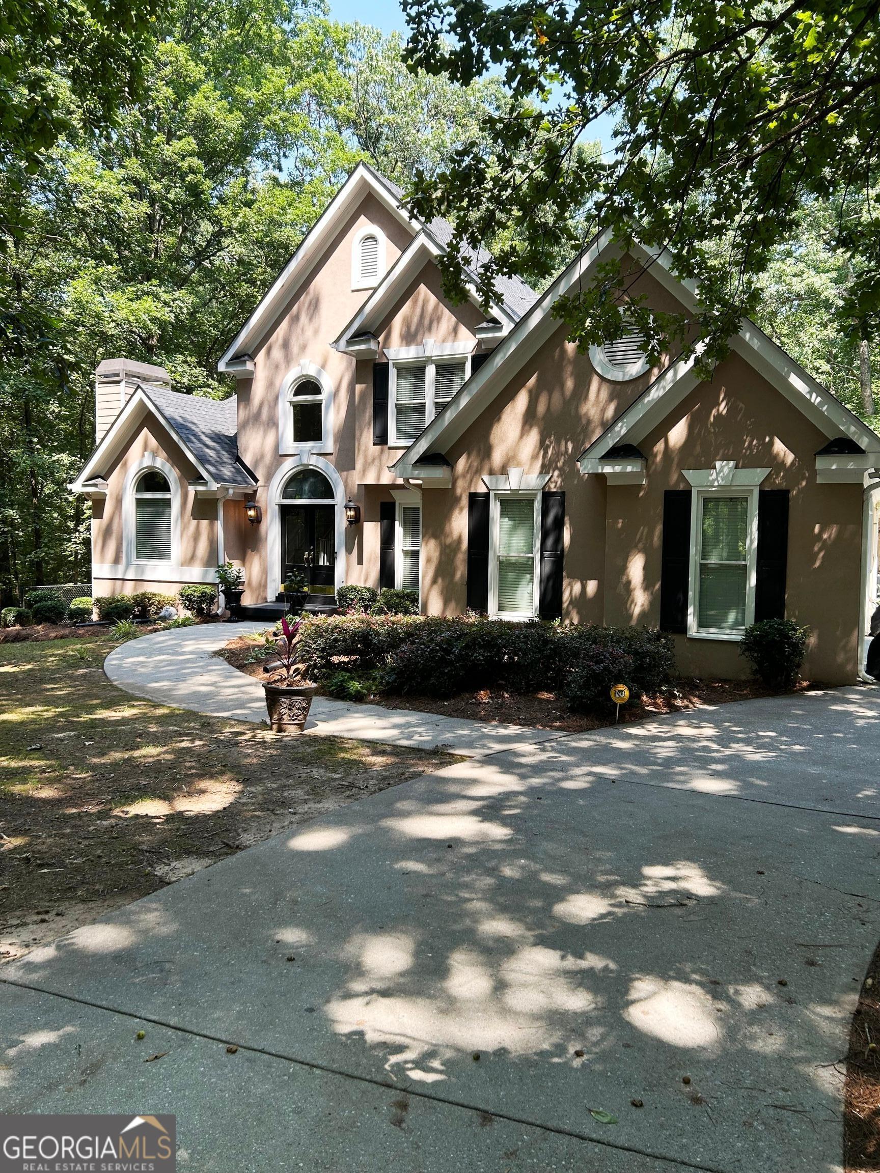Beautiful home on 3 private acres, side entry garage plus newly-built separate garage/workshop, IN-LAW SUITE with full kitchen-laundry-BR-BA-Den-bonus area-storage with boat door. Professionally decorated, recently painted and newer backsplash, 2-story entry and LR, trey in primary, hardwood and LVP in main and in-law suite. Fountain feature in front yard, extra paved driveway areas. Great school district! NOTE: New architectural shingles.