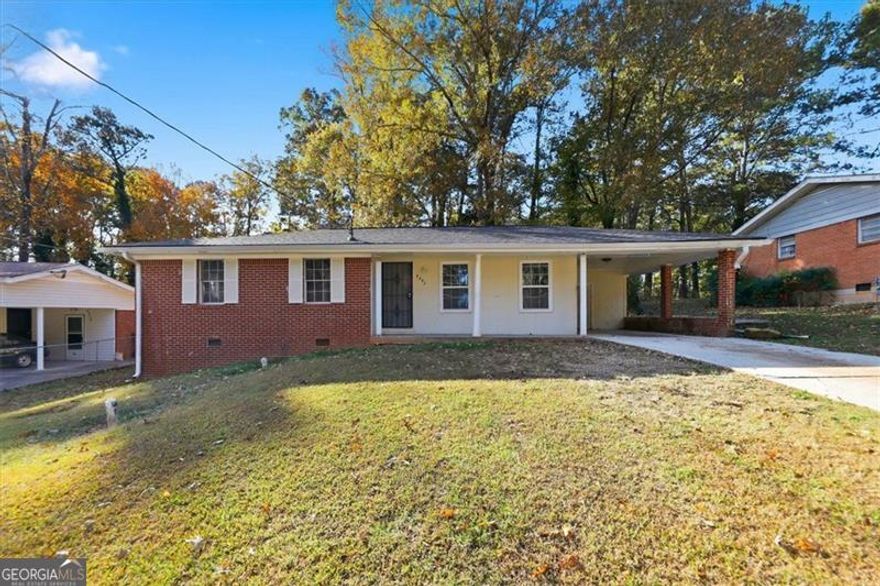 Welcome to this charming home with great potential, nestled on a spacious lot with a large front and backyard. As you enter, the living room sits to your right, seamlessly connected to the dining area, creating an open and inviting flow. Straight ahead, you'll find the kitchen, complete with a stove and microwave, while the bedrooms and bathrooms are conveniently located to the left. The expansive backyard offers plenty of space for outdoor activities or future enhancements. This home needs a bit of TLC and new flooring, but with the right vision, it can easily be transformed into a beautiful residence.