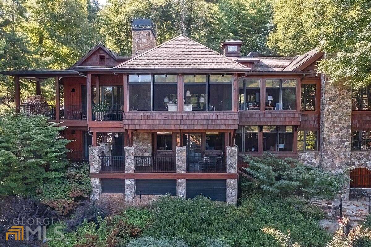 One of the most unique properties on Lake Blue Ridge is now available for purchase. This property is situated on 260+/- ft of lake frontage with a huge double slip dock with a sun deck, a swim deck and jet ski ports, on year-round deep water. In this particular location, you own to the water's edge...very beneficial and not the case with most LBR properties. This "smart" house has "Control 4" operation for cameras, thermostats, and lighting...it's not your typical "cookie cutter" lake house and has character galore! Its beautiful perennial gardens surround the house and flow down towards the water. There's an office over the garage, a wine cellar on the terrace level, screened porches, decks, a hot tub, an oversized fire pit, and so much more. There are two permitted septic systems in place on the property. A traditional system functions as primary with an Eljen system, as a backup.