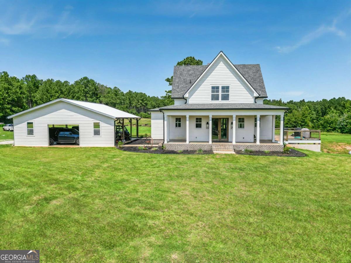 Welcome to 2711 Jordans Mill Road - a stunning estate offering 55 acres of rolling pasture and serene woodlands. This newly built residence combines modern luxury with timeless charm, featuring 4 bedrooms and 3.5 baths in a spacious open-concept design. The primary suite on the main level provides a private retreat, while the heart of the home showcases luxury vinyl plank flooring, custom cabinetry, and elegant quartz countertops with a large island perfect for gathering. Step outside to enjoy the expansive deck overlooking the pasture, a refreshing saltwater pool with a covered patio, and a 3-car carport designed for convenience. The property is fully equipped with irrigation and outdoor lighting, ensuring both beauty and functionality across the grounds. A barbed wire fence secures the perimeter of the 55 acres, offering peace of mind and ideal conditions for livestock or recreation. Additional features include basement storage for organization and flexibility, as well as light-filled interiors and thoughtful craftsmanship that reflect both comfort and sophistication. This is more than a home - it's a lifestyle of tranquility, space, and modern elegance