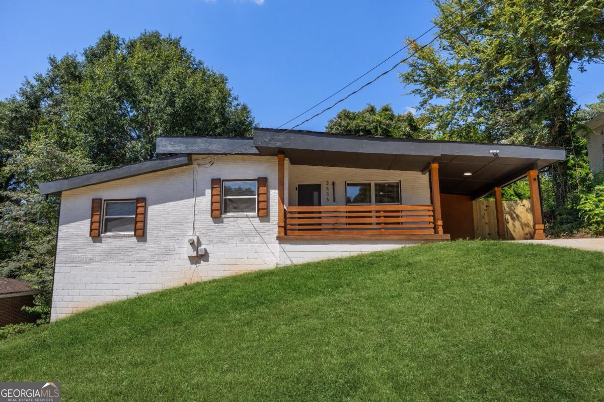 Step into Modern Luxury with this Fully Renovated gem in sought-after Gresham Park. This home is truly a rare find! The sun-filled 4-side Brick Ranch has all the right details and features you'll appreciate for years to come. Designed to impress, the open-concept layout boasts beautiful Hardwood floors and a dream Kitchen with Quartz Countertops, a Waterfall Island, Stainless Appliances, and Soft-Close Cabinetry. New roof, HVAC, Electrical, Energy-efficient Windows, and more make it feel like a brand new home. The Primary Suite is a true retreat with its own deck entrance, Cozy Fireplace and a Custom Walk-through Closet. The Luxurious Primary Bathroom includes an Oversized Shower with stunning tile work, Dual vanities, Soaking tub, and Dual shower heads. Enjoy endless opportunities to entertain with an oversized deck, and fenced yard, plus a basement for storage or future living space. Just minutes from I-20, I-285, East Atlanta, East Atlanta Village, Downtown Decatur, Downtown Atlanta, the new Halidom Eatery-Food Hall, Parks, Walking Trails, Restaurants and more! Don't miss out - schedule your showing today!