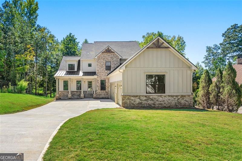 Welcome to this exceptional home in Traditions of Braselton, offering over 3,500 square feet of finished living space plus a 2,134 square foot unfinished basement with endless potential for customization. The floor plan is thoughtfully designed with two primary suites- one on the main level, featuring LVP flooring and a spa-inspired bath, and another upstairs-making it the perfect long-term home for families, multi-generational living, or empty nesters seeking comfort and flexibility. As you enter, you are welcomed by soaring ceilings and a double-height living area that fills the home with natural light and creates an inviting sense of openness. A versatile flex space on the main level offers the perfect setting for a private office, study, or playroom. The kitchen is a true centerpiece, featuring ceiling-height cabinetry, modern finishes, a built-in wine rack with chiller, and a wet bar/coffee bar that enhances both everyday living and entertaining. Attention to detail is evident throughout with custom wall treatments, stylish fixtures, and beautiful wood accents that provide warmth and character. The interior fireplace adds charm and comfort, while the outdoor fireplace anchors the generous exterior living space, perfect for gatherings or quiet evenings. Upstairs, secondary bedrooms are complemented by a spa-inspired bath experience, with both primary suites featuring shower and tub combinations designed for relaxation. The home is completed with a three-car garage featuring soaring ceilings, offering ample storage and utility space. The unfinished basement provides incredible potential for future customization-whether you envision additional bedrooms, a game room, a theater, or a home gym, the options are limitless. This residence combines elegance, functionality, and modern style, making it one of the most desirable floor plans in Traditions of Braselton. Schedule your showing today and discover a home that is truly move-in ready with room to grow.