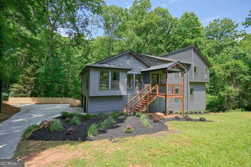**ENJOY INSTANT EQUITY AND EXCEPTIONAL VALUE AS THIS HOME IS PRICED $60K BELOW APPRAISED VALUE!** Welcome home to this meticulously renovated five bedroom, three bathroom contemporary home nestled on a quiet cul-de-sac in Stone Harbor subdivision. Enjoy your morning coffee on one of the two decks overlooking the tranquil creek beyond the newly fenced yard. The main level boasts an open floor plan with vaulted ceilings; an amazing chef's kitchen with stunning finishes that include quartz countertops, a massive island, all new stainless steel appliances, and gas range; and luxury vinyl plank grace the floors in the entire home. The kitchen and dining spaces open up into an expansive great room with a striking vaulted stone fireplace and outdoor deck. The upper levels contain two bedrooms and one shared bathroom with beautiful tile, new tub and vanity with quartz countertops. Down the hall is conveniently located the laundry area adjacent to the primary suite. The large primary suite has a stunning and relaxing spa wet room with dual headed shower and free standing bathtub. The double vanity has quartz countertops and top of the line gorgeous finishes. In addition, there is a spacious primary suite closet as well. The lower level has a family room flex space with french doors leading out to an expansive deck as well as two bedrooms and one full bathroom. The basement level consists of finished and unfinished areas with soaring ceilings for additional living, entertaining or work spaces. More windows were added by the seller to illuminate this great space. A new modern fence was added to the backyard to create your own private oasis. This home boasts worry free maintenance since it has new everything! New Roof, HVACs, Water Heater, Doors, Windows, Garage Doors, Wood Decks, Fencing, Appliances, Lighting and Freshly Painted. No HOA.
