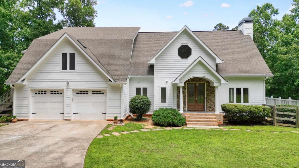 Tired of seeing the same builder-basic floor plan over and over again? This home is definitely not another copy-paste floor plan from the cookie-cutter catalog. If you're craving something unique, private, and full of character-Seldom Seen Acres delivers. Located on 5 serene acres in the heart of Hickory Flat, this custom Cape Cod-style home was once the residence of renowned Georgia oil painter Damon Carter and offers a rare blend of comfort and creativity. With a fresh third-party appraisal on file, it's priced right at value for today's market with the added bonus of NO HOA! A perk test has been completed, and records are available for those looking to potentially subdivide off 2 acres of the land in the future. A gated, tree-lined driveway leads you to this natural light-filled, move-in ready home featuring hickory hardwood floors, vaulted ceilings, and fresh paint inside and out. The heart of the home is a vaulted great room with a striking stacked-stone fireplace, dining area with room for a 12+ seat dining table, and panoramic views of the Jr. Olympic saltwater pool. The adjacent kitchen shines with Calacatta quartz countertops, warm wood cabinetry, and updated lighting. The main-level primary suite features a bay window, custom walk-in closet, and a 2025-renovated ensuite. Upstairs offers a loft, a bedroom with three closets, full bath remodeled in 2025, and a second oversized bedroom-formerly Damon Carter's art studio-with a private entrance, wet bar, and endless possibilities for a bedroom suite, office, or creative space. The finished, daylight terrace level (updated in 2022) offers two more bedrooms, a full bath, family room, and office/flex options. Outside, enjoy a 20x40 Jr. Olympic saltwater pool, waterfall, and LED lighting. This property also includes an oversized two-car garage (with space for large trucks or a workshop), RV/ATV parking, and multiple fenced areas for gardening or pets. Located just minutes to Milton and Alpharetta, shopping, and dining-yet completely tucked away from it all-this home is also zoned for top-rated schools: Avery Elementary, Creekland Middle, and Creekview High. Per seller, Cherokee County has plans to pave and widen Seldom Seen Trail.