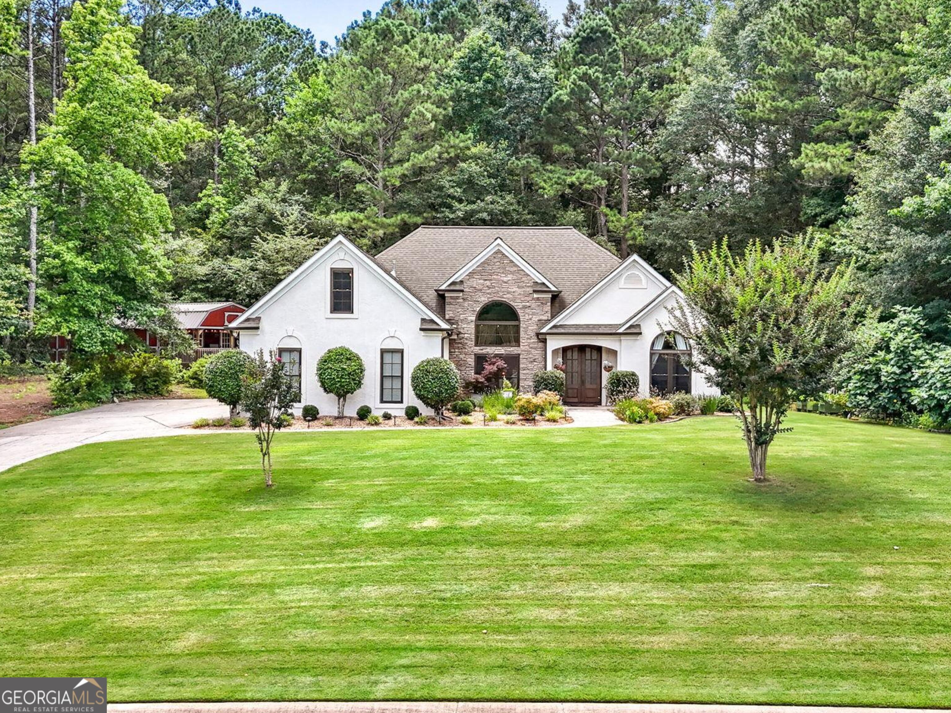 Location, location, location! Welcome to this beautifully updated and move-in-ready split ranch home with bonus upstairs (can be 4th bedroom) nestled in the heart of it all! Cannongate Elementary, Madras Middle & Northgate High school districts! 7 minutes to Costco, Sam's & Publix. 8 minutes to Peachtree City. 5 minutes to Tyrone. 10 minutes to Newnan. 20 minutes to ATL airport. Set on a private & spacious lot with no HOA. This charming property blends modern comfort with outdoor living plus room for future pool. Step through the extra tall & substantial mahogany double front doors, surrounded by luxurious custom trim and onto the Italian imported porcelain tile into a natural light flooded place called home. Immerse yourself under the glow of hand blown glass light fixtures and stroll through the thoughtfully flowing floorpan with touches of luxury that will make you never want to leave. Custom kitchen and bath cabinets with slide out shelves in pantry. Elegant and resilient hickory hardwood floors throughout with newer carpet in secondary bedrooms and bonus. Take a stroll out back onto the very private covered & screened back porch plus an open concrete patio for good old cookouts. Visit the side garden with blueberry bushes, fruit trees and many other flowering bushes around the property. 2 car garage with extra wide driveway. Parking for trailers, RVs, boats etc. Chicken coop ready for up to 20 chickens. Amazing 14x30 insulated, heated & cooled shop with 100 Amp power, loading ramp, loft and the perfect rocking chair front porch to sip your sweet tea. Can even make this a wonderful tiny house. (2025): Septic pumped and inspected, ceilings painted. (2024): Pella windows and gutters, garage door & WiFi opener with windows, custom mahogany front double doors with privacy windows, fresh paint interior and exterior. (2021) 14x30 Shop added to property. Guest Bathroom remodel. (2019) Luxury master bath remodel, Custom closet system. New carpet upstairs. (2018) Water Heater, light fixtures (2017) HVAC, Hickory Floors, kitchen/fireplace/porch remodel. Schedule your private showing today-homes like this don't last long! Owner licensed real estate agent in the state of GA.