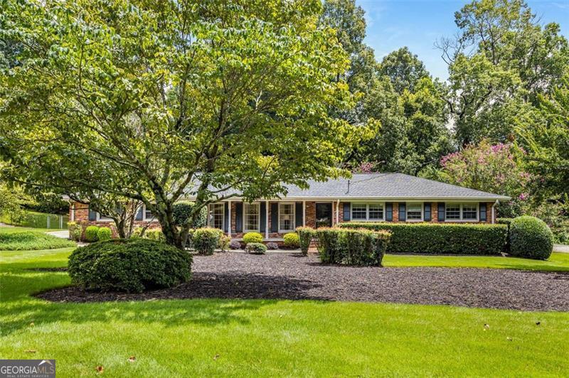 Tucked away in North Atlanta (DeKalb), this four-sided brick Mid-Century Modern Ranch/Rambler house is a place where timeless style and Modern Comfort connect. The moment you arrive, you can see and sense the Harmony and peace of this home. The professionally landscaped yard adds natural beauty. Inside, you will discover an atmosphere of warmth, beauty, and refinement. The remodeled kitchen is the heart of the home. It is wonderfully updated, yet it offers a clean and classic look including updated hardwood flooring, Modern Cabinets, farmhouse sink, and stainless appliances. Each of the three bedrooms offers a private sanctuary, and both full bathrooms have been tastefully updated to elevate everyday living. The fenced backyard is beautiful with lush grass that makes you want to take off your shoes and relax. You will feel grounded and uplifted. Perfect for your four-legged family member, too. With a spacious 2-car garage, proximity to great schools, and nearby access to parks, shopping, and dining, this home is more than a place to live. You will feel at home. It's Turn-Key, Move-In-Ready! What are you waiting for? Call your movers. Your New Home is waiting for you!