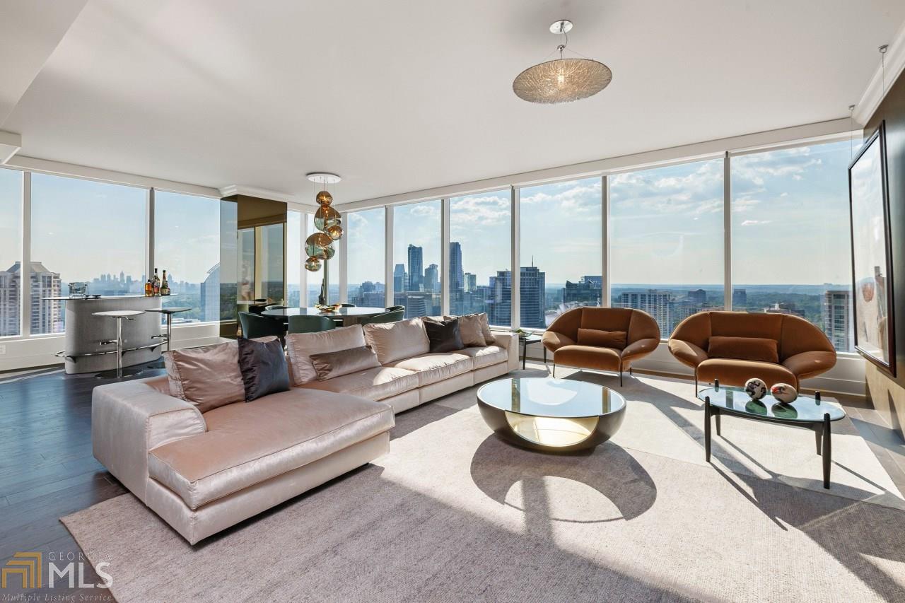 Ritz-Carlton Residences Buckhead - - Stellar Unobstructed City, Sunset and Skyline Views. Premier South Facing '03' Corner Unit. Renovated to Perfection. Large Open floor plan with 2 terraces. Most sought after floor plan and views. 3 Parking Spaces + 2 Storage Units. New Solid Oak Hardwood Floors, Armani/Elitis/Rubelli Wall Coverings, Remodeled Closets, Stunning Porcelain Wall Panel with Hidden Door in Great Room, Bronze Mirrored Dining Column, Cesar Stone Kitchen Countertops/Backsplash, Robern Bathroom Vanities, New Tile, New Master Bathroom Shower/Tub, Glass Barn Doors in Guest Room, New Bathroom Mirrors . Automated Shades throughout.  Unparalleled Ritz-Carlton Amenities & Services include: 24-hour Valet Parking for Residents/Guests + Concierge.