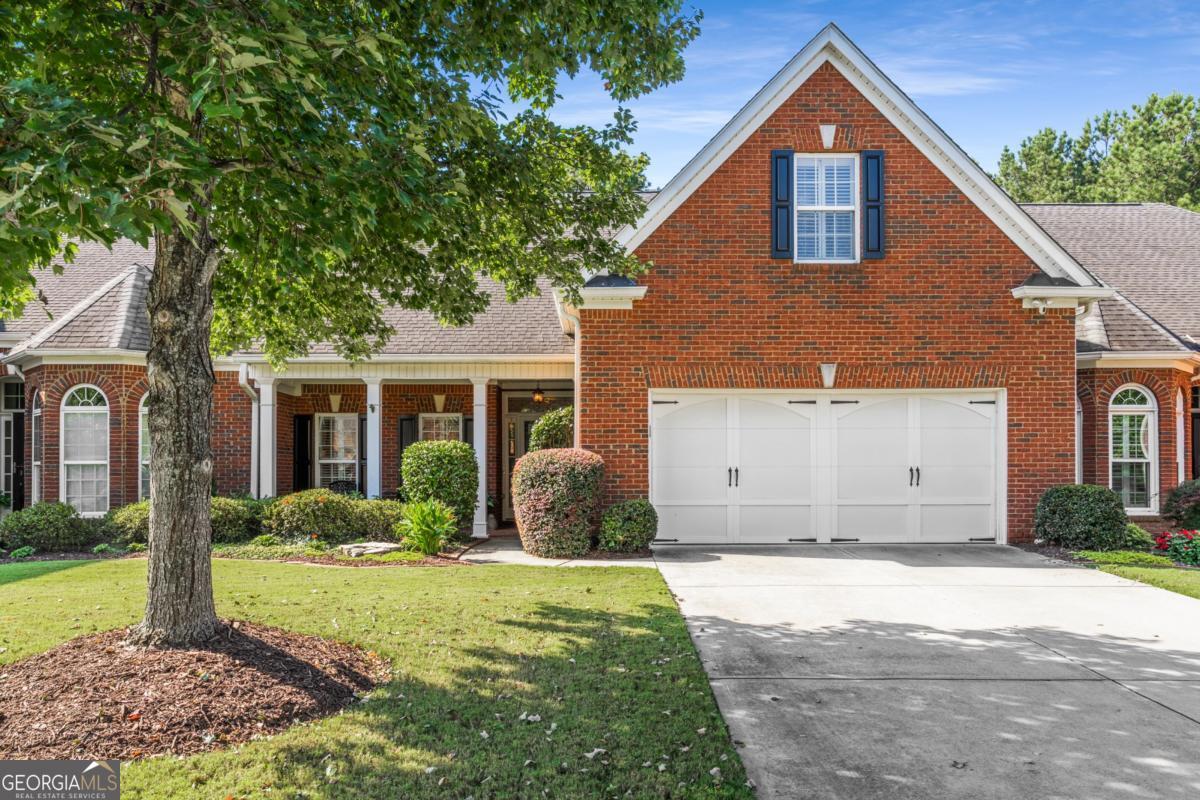 Welcome home to the Villas at Laurel Springs! A Stylish Stepless-Entry Townhome with Primary on Main in Prime Suwanee Location! Thoughtfully renovated and move-in ready, this home combines modern upgrades with timeless details in a community that offers both convenience and lifestyle. The vaulted primary suite on the main level offers everyday comfort, while soaring ceilings and two solar tubes flood the home with natural light. Fresh neutral paint and all-new hardwood flooring on the main level create a bright, inviting feel throughout. The open floor plan features an updated kitchen with new cabinetry, countertops, and appliances, open to the family room for seamless living. A separate dining room with a tray ceiling adds elegance, while the flex room is perfect as a sunroom, breakfast nook, or home office. A convenient pantry and main-level laundry complete the thoughtful layout. Two secondary bedrooms with adjacent full baths-one on the main and one upstairs-offer flexibility for guests, work-from-home space, or hobbies. Tasteful finishes including arched openings, generous millwork, and a stone-tile fireplace elevate the style of this home. Outdoor living is just as appealing, with a welcoming covered front porch and a private backyard featuring a stone patio with a pergola and fenced yard-ideal for relaxing or entertaining. The home also includes a two-car garage and level driveway for easy access. The Villas at Laurel Springs community enhances your lifestyle with walking paths, tennis courts, and a clubhouse complete with an exercise room. Conveniently located near Suwanee and Johns Creek, you'll enjoy shopping, dining, and parks at your fingertips. Plus, the home is zoned for top-rated Forsyth County schools with easy access to Peachtree Parkway, GA-141, and GA-400. Offering the best of convenience and design, this is the one you've been waiting for.