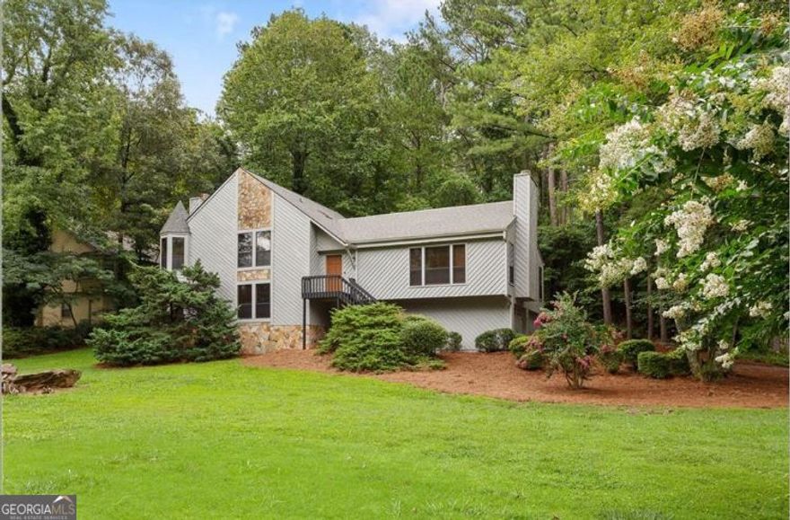 Welcome Home! Located in the highly desirable Pope High School district, this beautifully maintained tri-level Marietta home is move-in ready and packed with recent updates for peace of mind. Big-ticket items have already been taken care of with a brand-new HVAC system (heating 2024 & AC 2025), new roof (2022), whole-home PEX plumbing replacement, and a Terminix termite bond in place.  Step inside to find fresh, neutral paint and brand-new carpet throughout the upstairs. The bright, open floor plan flows effortlessly from the spacious living room to the dining area and kitchen-perfect for everyday living or entertaining.  Downstairs offers even more versatility with a second living space that can be used as a game room, play room, or office. Off of this space is an additional bedroom with its own full bath, ideal for a teen retreat, in-law suite, or private guest quarters.  Sitting on one of the only flat lots in the neighborhood, this corner property gives you plenty of room to enjoy the outdoors. Plus, the optional HOA offers flexibility, while the Post Oak Springs Recreation Club right across the street provides swim and tennis amenities-join only if you want to!    This home is priced to allow you to add personal upgrades over the years, yet it's move-in ready today with all the essentials already handled. Conveniently located near shopping, dining, parks, and top Cobb County schools, it's the perfect balance of comfort, versatility, and long-term potential.