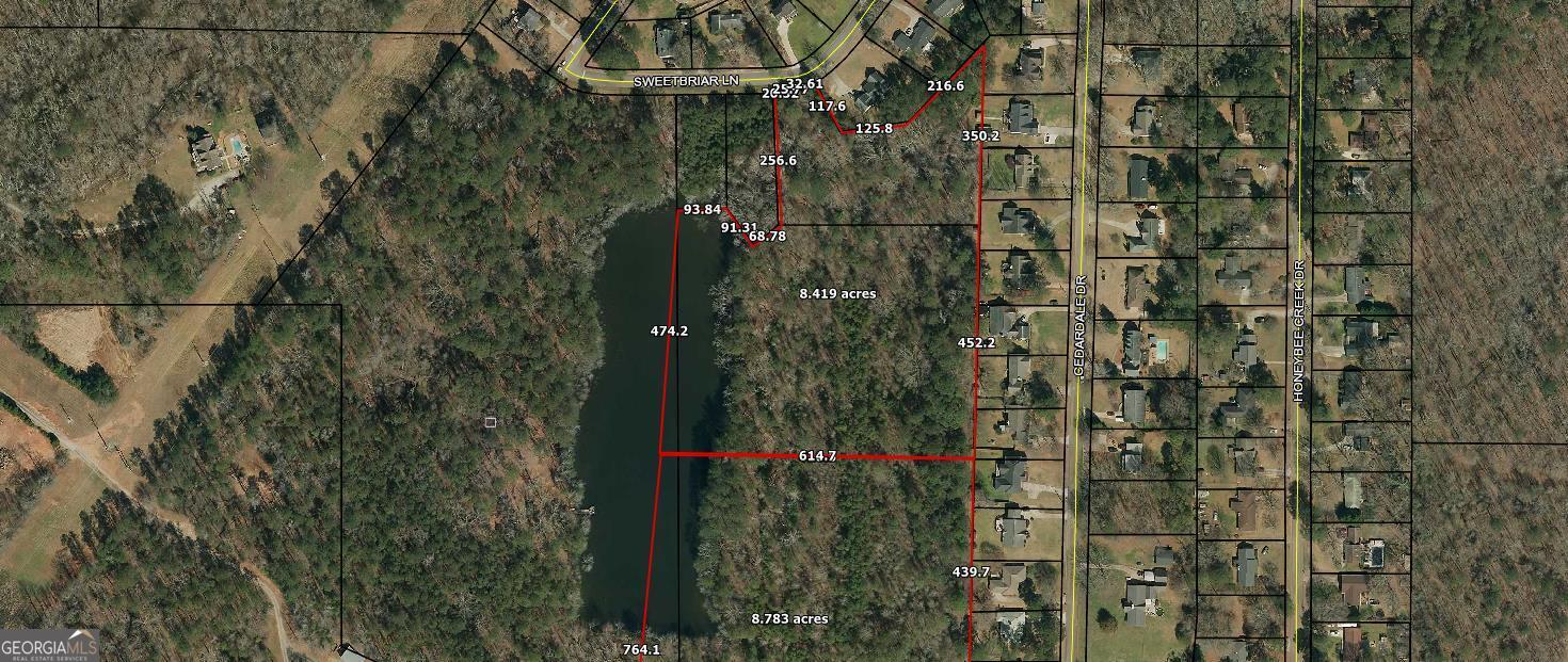 Beautiful lake tract for sale. Seller is willing to divide into 2 tracts with a minimum of 8 acres. One end has City of Griffin access with 80 feet of frontage on Sweetbriar Lane and all City utilities including sewage. North end includes Tract C with is 2 acres and is a city lot. Tract 2 has 135 feet of access on Cedardale Drive. Price is 17,500 per acre if all 17 acres are purchased.