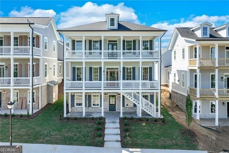 **Special Financing Available **One of the distinctive "Six Sisters" at Homestead at Hog Mountain, this charming property was crafted by one of our preferred architects, Alison Ramsey, drawing inspiration from San Francisco's iconic "Painted Ladies". This adaptable plan, artfully designed for versatility, boasts 5 bedrooms and 5.5 bathrooms, and is gracefully spread across three levels of living space. Highlights include an open kitchen with a central island and dining area, a cozy study or office complete with a fireplace, a bright and airy sunroom, and a spacious family/media room equipped with a built-in kitchenette. Additionally, with its own entrance, the lower level offers private access and encompasses 2 bedrooms, 2 bathrooms and the family/media room with kitchenette. Along with the unfinished ADU space above the garage, this thoughtfully crafted layout allows the home to adapt to your needs and provides an ideal haven for multigenerational living options.