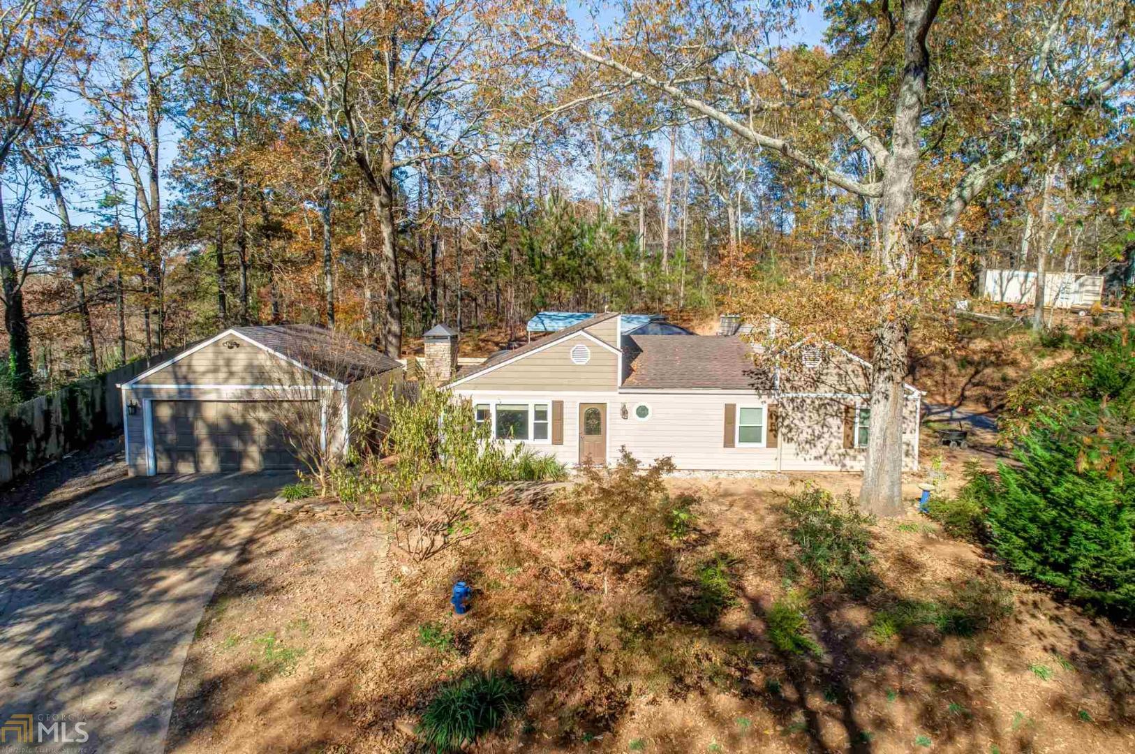 Beautifully updated ranch located conveniently off Hwy 92 between I-575 & I-75. Large lot that sits on over 1 acre. Open concept with an island, granite countertops, gas stove top and vent hood. New flooring and paint! Long driveway with a large detached garage. Outside storage area, patio, gazebo with trellis this home truly has it all!