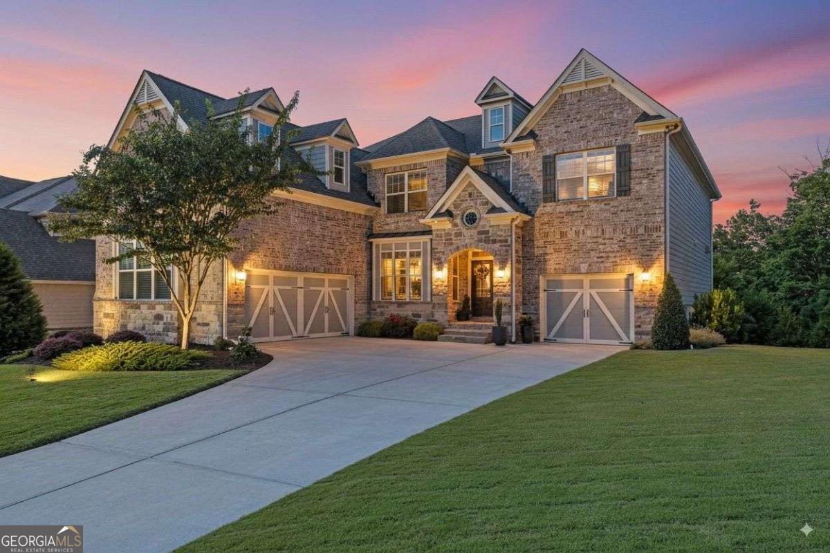Welcome to your dream home at 2765 Crowbrook Way, nestled in the highly sought-after Mountain Crest Community! This 5-year-old home offers better than new construction at a price that cannot be beat! Recent upgrades include $50,000 in professional landscape improvements, professionally installed exterior lighting, new exterior paint, garage and patio floor coatings, a tankless water heater, and whole house surge protector. Over 4,200 square feet of finished space plus almost 2,000 square feet of unfinished basement with electrical installed offers so much room to impress your family and friends. This spacious 5-bedroom, 4-full bathroom residence offers the perfect blend of modern living and resort-style amenities, all within the top Forsyth County Schools. Step inside to discover a spacious and inviting floor plan designed for ultimate comfort and entertaining. The main level features a gourmet kitchen with huge walk-in pantry, enough granite countertops and cabinets for even the most decerning chef, a breakfast area, separate dining room, sunroom, and family room with stone, gas fireplace and built-in shelving. The main level also offers a bedroom with full bathroom, perfect for an in-law suite. Upstairs you will find a gigantic owner's suite. It features a separate sitting room with gas fireplace, dressing area, massive closet, and secluded office just off the owners closet. The owner's bathroom is also oversized with an extended double vanity, shower, and soaking tub. You also have direct access to the upstairs laundry room from the owner's suite. But wait, there's more! The upper level also features two bedrooms with a connected bathroom, with separate, private vanities. As well as a fifth bedroom with an en suite bathroom. Outside, you can entertain family and friends on the beautiful, covered deck that features another stone fireplace. The professionally landscaped yard features lush plants, extended patios for grilling and entertaining, a walking path, and fire pit. Even better, no neighbors directly behind you. It is truly a dream backyard! This property is more than just a house; it's a lifestyle, perfect for multigenerational living. The Mountain Crest community is known for its incredible resort-style amenities, ensuring every day feels like a vacation. As a resident, you'll have access to the community pools and waterslide, clubhouse, freshly resurfaced six dedicated pickleball courts, five tennis courts, fenced basketball court, playground, and walking trails. Bonus: Your yard maintenance and trash is included in your HOA dues. Located in top-rated Forsyth County, this home is zoned for Kelly Mill Elementary, Hendricks Middle, and Forsyth Central High Schools, offering an exceptional education. With its prime location, unparalleled amenities, and a beautifully crafted home, 2765 Crowbrook Way is the perfect place to create lasting memories. Don't miss your chance to experience the best of Cumming living!