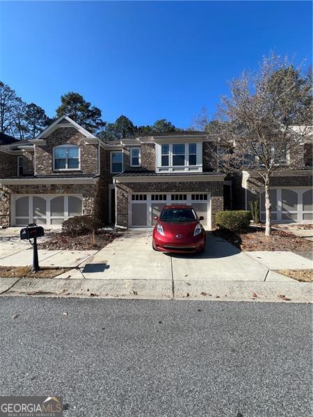 Location, Location, Location! Welcome home to this fabulous, better-than-new, luxurious 4-bedroom, 3-bath townhome in the gated swim community of Hidden Forest. Nestled in a family-friendly community with top-rated schools (Alpharetta HS), this serene oasis offers a perfect blend of modern living and convenience. Located just moments from GA 400, Avalon, and Halcyon, you'll enjoy easy access to shopping, dining, and entertainment while being surrounded by lush greenery in the heart of Milton and Alpharetta. This bright and beautifully maintained home features an open floor plan with dark hardwood floors throughout the main level and an elegant staircase adorned with wrought-iron balusters. The gourmet kitchen boasts top-of-the-line stainless steel appliances, a large island, breakfast bar, dark cabinetry, luxurious granite countertops, and a tiled backsplash. The huge kitchen flows seamlessly into the fireside family room and dining area, illuminated by a wall of windows. A glass door leads to the rear deck, offering the perfect spot to relax. A guest bedroom and full bathroom are conveniently located on the main level perfect for guests, in-laws or parents. Upstairs, the enormous owners suite impresses with a sitting area, large windows, and a spa-like bathroom featuring a garden tub, a separate glass shower, dual vanities, and a spacious walk-in closet. Two additional bedrooms, an updated full bathroom, and a laundry room complete the upper level. This home has granite countertops, stainless steel appliances, and tiled bathroom floors. The gated community offers fantastic amenities, including a swimming pool and a dog park. Don't miss your chance to RENT this secluded gem.