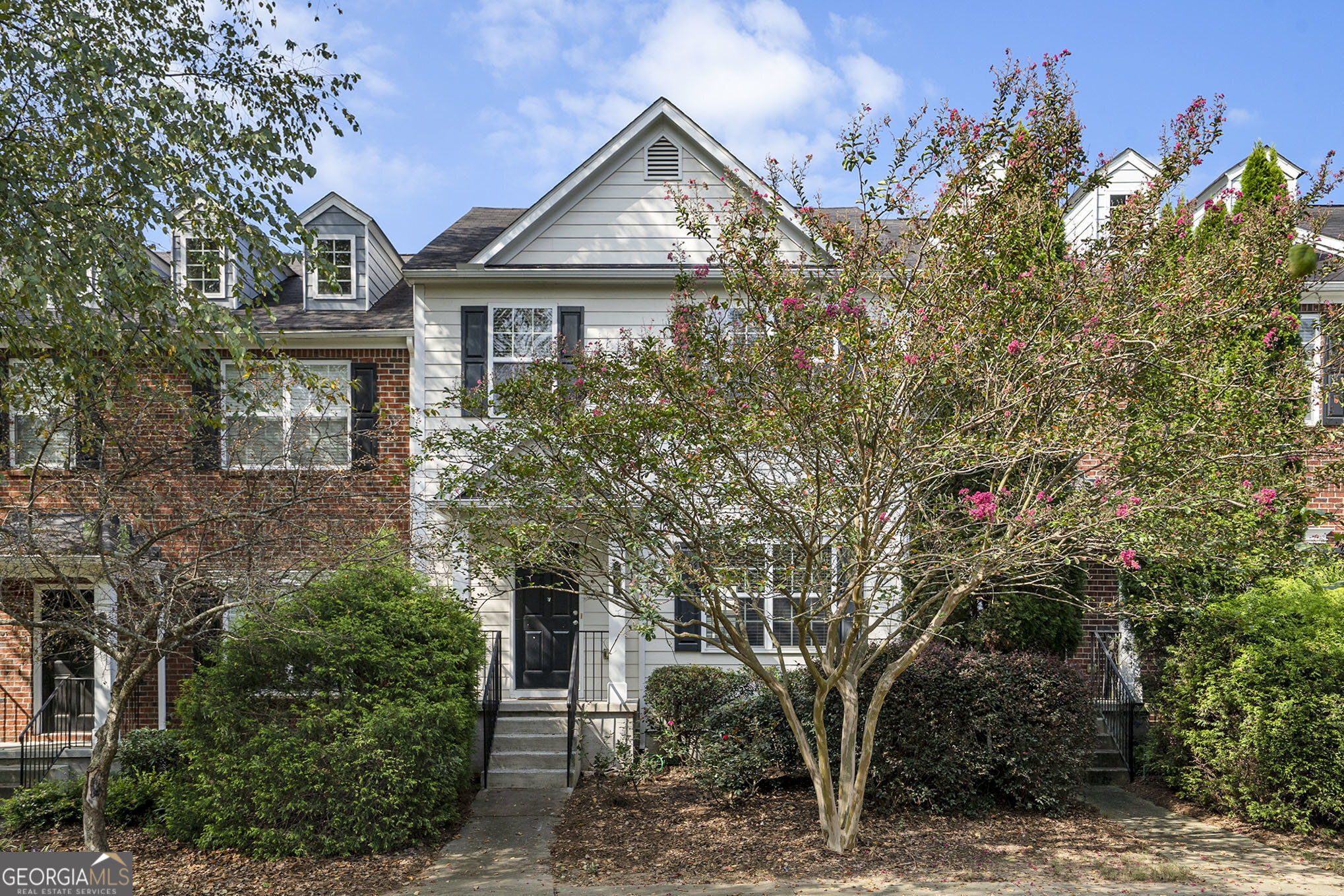 Beautifully maintained 2-bedroom, 2-bath townhome in the highly desirable Magnolias at Ridge Walk swim/tennis community! Conveniently located near Olde Rope Mill Park, Downtown Woodstock, and The Outlet Shoppes at Atlanta, this home offers the perfect blend of comfort and convenience. A charming front porch welcomes you into a bright, freshly painted interior with gleaming hardwood floors throughout the main level. The kitchen features stainless steel appliances and opens to a spacious dining area with access to a large back deck-ideal for entertaining. Relax in the inviting living room with a cozy fireplace. Upstairs, you'll find generously sized bedrooms with ample closet space. The lower-level bonus room offers versatility, perfect for a home office, gym, or game room.