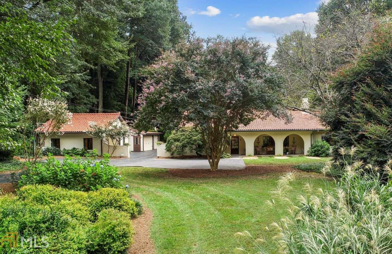 Magnificent Gated Mediterranean Compound on 2 +/- Acres in the Heart of Buckhead. Pool &Tennis Court. Main House 3 BR/ 4 Baths -2 Guest Houses, 4 Car Garage plus additional 2 car garage & workshop. Foyer, Fireside LR w/ Vaulted ceilings. Separate DR, custom kitchen w/ quartzite counters,Kitchenaide 6-burner range w/ double ovens, stainless appliances, walk in pantry & cozy breakfast nook.Den is open to the kitchen&has full bath. Small Office off Bedrooms. Renovated Owners suite includes oversized BR w/ beamed ceilings, doubles sets of sliding French doors leading to outdoor patios & walkways, corner fireplace & sitting area.Owners bath includes separate marble vanities, marble dressing vanity, separate closets w/ custom built-ins & separate water closets.  The glass enclosed "wet room" includes European shower w/ stand alone jetted tub. The main courtyard w/ fountain leads to separate great room w/ vaulted Beamed Ceilings,Bookcases,wood-burning FP,wet bar &half bath. 2 Guest Houses each w/ BR& Baths & morning kitchens.2 Laundry Rooms, Large exercise room in unfinished basement & tons of storage. Landscaped yard w/ flowering plants and trees throughout each season.  There is a tennis court and pebble-tech pool w/ shelf & 2 fountains.  The property has a well and 2 cisterns which feed the irrigation system.