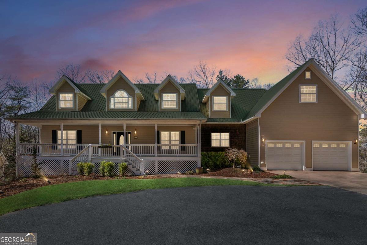 Escape to the Northeast Georgia mountains and discover this impeccably maintained, 5-bedroom, 5,422 sq ft home on 3.86 private acres. Located just 4 miles from downtown Dahlonega, this charming ranch-style home with a master on the main plan offers the ultimate retreat, perfect for entertaining friends or large family gatherings.The heart of the home boasts a fully renovated chef's kitchen featuring a large island, quartz countertops, stainless steel appliances, a counter-depth refrigerator (included), a 5-burner Wolf Range, a warming drawer, and a professionally organized walk-in pantry. The inviting open floor plan includes a spacious living room with a stone fireplace and beautiful hardwood flooring. Two sets of double doors lead to the 4-seasons sunroom, a rustic cabin-like space with a refreshment bar, perfect for listening to nature or watching a game. The oversized master suite, conveniently located on the main level, includes a huge, professionally organized walk-in closet and double doors accessing a private deck. The master bathroom, updated in 2019, features dual quartz vanities, heated floors, a freestanding soaking tub, and a separate shower. An additional bedroom on the main floor is ideal for guests or a home office. The upper level includes a huge media/movie room with surround sound and recessed lighting, two spacious bedrooms with a full bathroom and a half bath. A large bonus room over the garage provides walk-in climate-controlled storage.Recently and professionally finished in 2023, the lower level is ADA compliant and offers a beautiful in-law suite. This suite includes a full kitchen, family room, a large bedroom and bathroom, washer/dryer hook-ups, and storage with a tankless water heater. With a private driveway entrance, this space is perfect for renters, in-laws, or even Airbnb potential.The property is surrounded by mature landscaping, including Japanese maples, flowering plants, and blueberry bushes. A two-tiered deck, overlooking the fenced backyard, is made of durable EPAY wood and is perfect for entertaining. A screened porch offers another spot for relaxation.The property also includes a whole-house generator, RV electrical hookup in the lower driveway, and a garden shed (or workshop) with electricity. HVAC units are less than 2 years old, the septic was serviced in 2022, and a second septic tank was added with the basement renovation in 2023. Two gas tanks (350/500) are also on the property. Conveniently located minutes from the new hospital, upcoming Publix, and GA 400, this home is only an hour from Atlanta's Hartsfield-Jackson Airport. Enjoy easy access to North Georgia's scenic treasures, wineries, shopping, and dining.