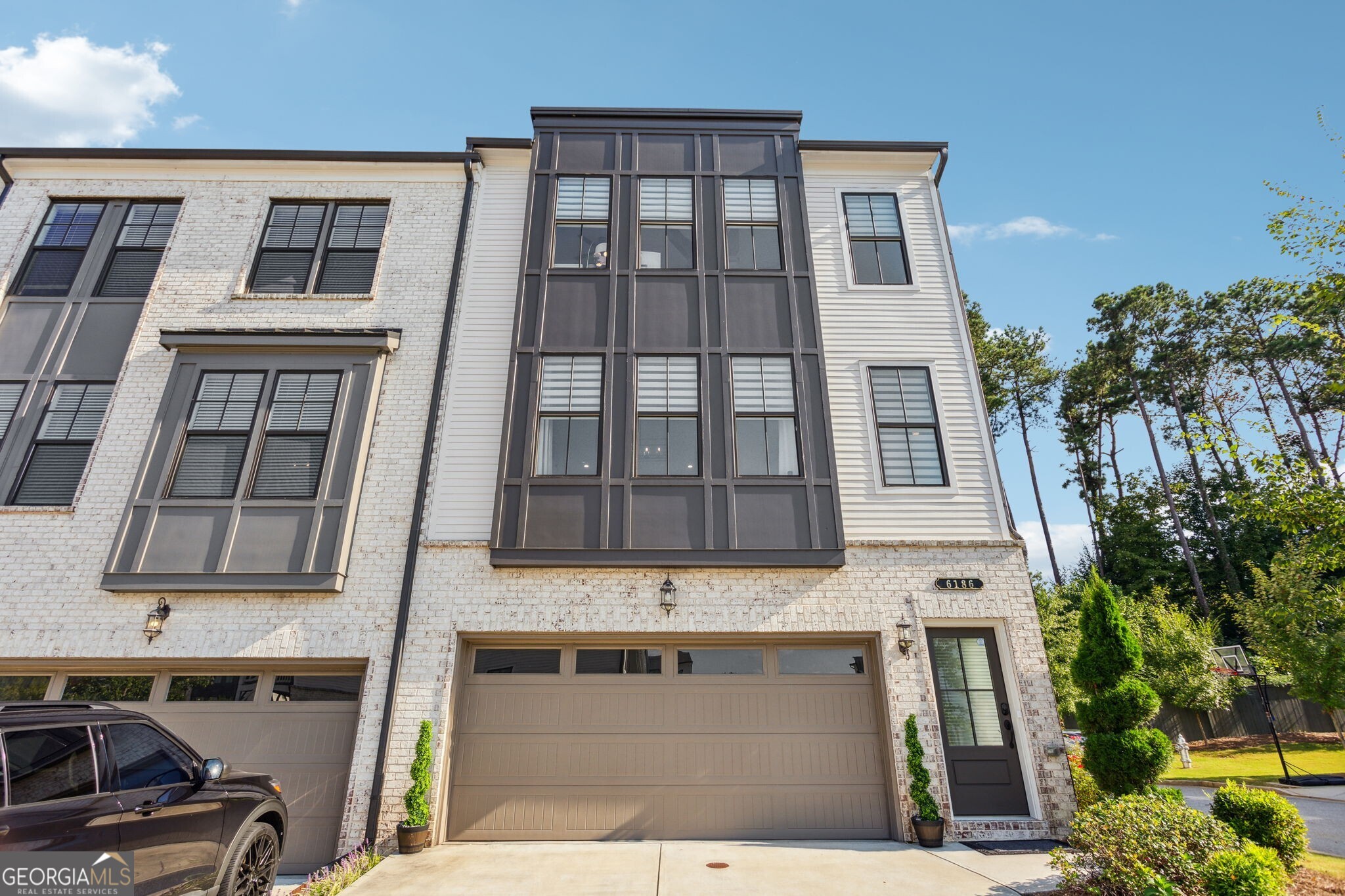 Walkable to downtown Norcross, this move-in ready end-unit is the perfect place to call home! As you enter the property, you will immediately feel wrapped in luxury and comfort. Head up the stairs to your beautiful, open-concept living space with a separate dining room that has custom, grass-cloth wallpaper. The excess windows pour in an incredible amount of natural light, but if you need some privacy, you can adjust the zebra blinds found on just about every window. And if you are concerned about noise, you can find comfort in knowing that the windows on the back of the unit are specifically designed for sound-proofing. Double doors will welcome you onto your covered patio that you can enjoy rain or shine. Head upstairs to find your generously sized primary suite with two closets and a large bathroom including a double-vanity and water closet. Two secondary rooms make for the perfect guest space, office space, or both! Heading down to the terrace-level, the full bathroom makes this space impeccable for whatever your heart desires-- a man-cave, playroom, guest suite, etc. You will absolutely fall in love with this dog-friendly, community-focused neighborhood! Don't miss it!