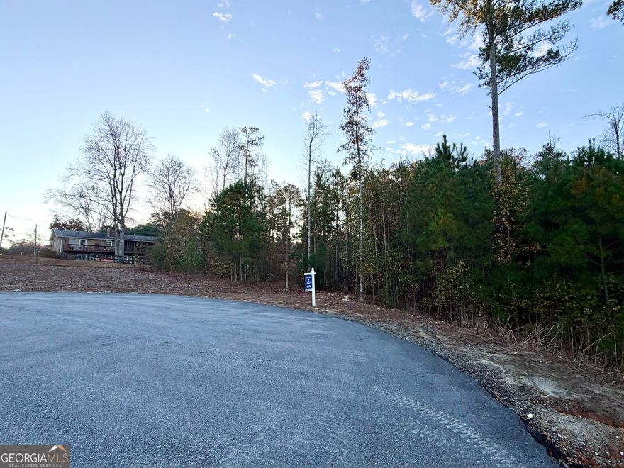 Discover this ready-to-build 1.67-acre estate lot nestled in one of Woodstock's most desirable locations - truly a rare find! Create your dream home in a prestigious, estate-style community offering the perfect blend of privacy, convenience, and charm. Enjoy the best of both worlds - peaceful living just minutes from it all. Located only 15 minutes from GA-400 and I-575, and within 10 minutes of Downtown Woodstock, Downtown Roswell, and Crabapple/Alpharetta, this homesite offers unparalleled access to shopping, dining, and entertainment. This is your chance to design your private oasis in the heart of a vibrant, thriving area. Don't miss the opportunity to make your dream home a reality on this stunning piece of land!