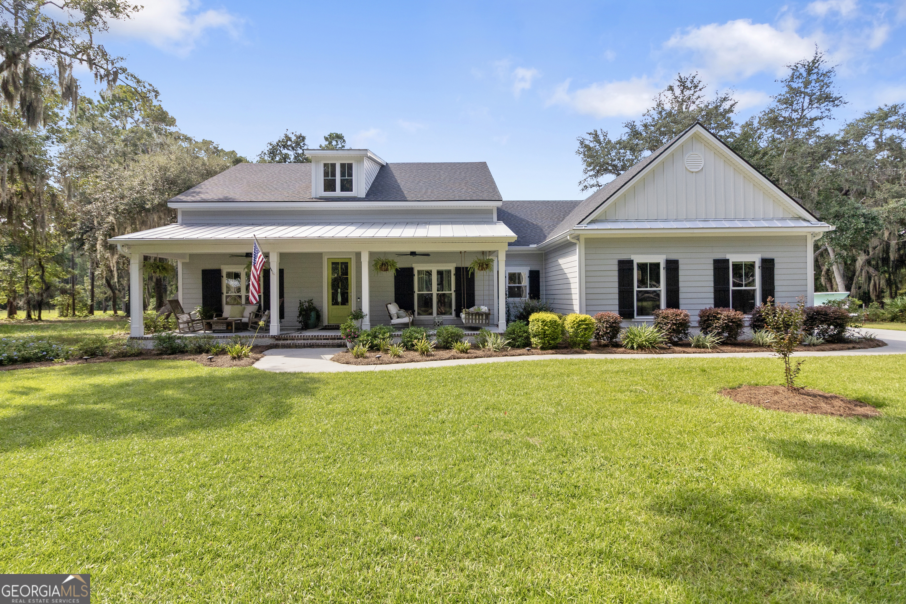 Welcome to effortless Lowcountry living! This better than new custom 2022 single-level home rests along the fairway of Sapelo Hammock Golf Club inside the double gated Sutherland Bluff Plantation, where coastal beauty and Southern hospitality abound. Thoughtfully designed, the open-concept layout combines modern convenience with timeless style. The kitchen showcases sleek cabinetry, stainless appliances, a gas stove, and a large island that flows into the dining area and living room. Anchored by a gas fireplace framed with custom built-ins, the living room offers both warmth and timeless Lowcountry style, while large windows throughout the home fill it with natural light and peaceful golf course views. Automated lighting and blinds, easily controlled by touch or Alexa, add comfort and ease. The split floor plan offers two spacious guest suites with private baths, plus a convenient half bath for visitors. The primary suite is a true retreat with tranquil views, spa-inspired bath featuring a soaking tub, oversized dual-head shower, double vanities, and a boutique-style walk-in closet with chandelier and center island. High ceilings, designer finishes, and wide-plank flooring carry Southern elegance throughout. Outdoor living is at the heart of this home. The living room extends effortlessly outdoors through an expansive wall of sliding glass doors, opening to a huge screened back porch with full outdoor kitchen, dining, and lounge area. Evenings are best spent around the custom-built fire pit, where sunsets paint the sky. A side-entry two-car garage plus golf cart garage enhances curb appeal and provides practical storage. Whether sipping coffee on the patio or unwinding in the owner's suite, every detail reflects thoughtful design and quality craftsmanship. Low-maintenance extras include covered gutters with leaf guards, a whole-home water softener, and sprinkler system. Sutherland Bluff offers more than a home-it's a lifestyle. Stroll beneath ancient live oaks alive with coastal wildlife, take advantage of the community pool, fitness center, tennis courts, and walking trails, or launch from the deep-water dock on the Sapelo River. From here, a quick boat ride brings you to the Intracoastal Waterway and the unspoiled barrier islands of St. Catherine's, Blackbeard, and Sapelo. Conveniently located less than 15 minutes to I-95, about 30 minutes to Richmond Hill, 40 minutes to Brunswick, and under an hour to Savannah and Jacksonville airports, this home is as accessible as it is serene. Blending modern convenience with the grace of the Lowcountry, this home is perfect for those who want to entertain with ease, embrace the outdoors, and enjoy the charm of Shellman Bluff.