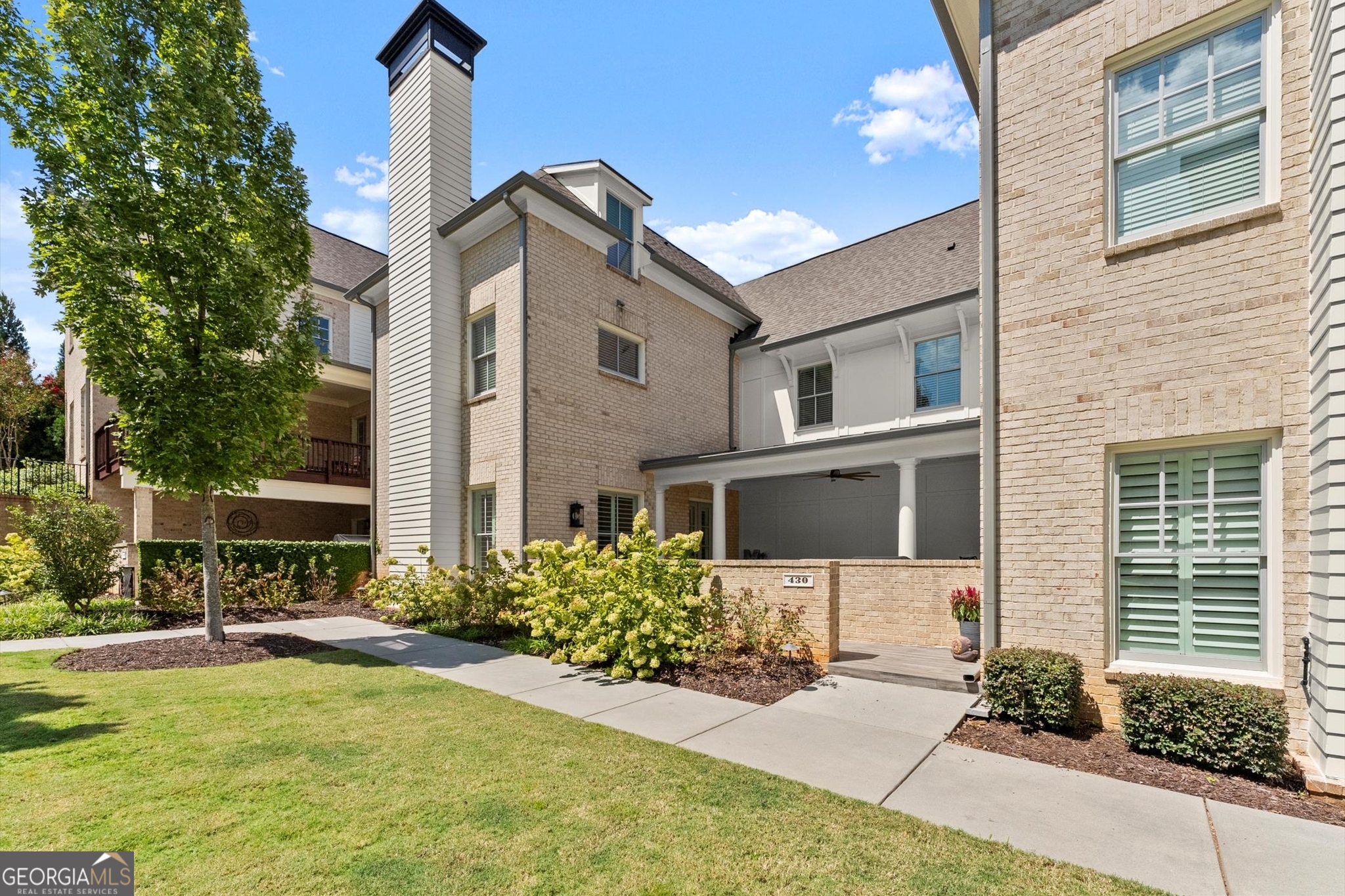 Don't miss out on this gem of a home in the most amazing location in downtown Roswell! Steps from farmer's market, and all Canton St has to offer, yet tucked back on a quiet and serene street. This gorgeous home is better than new construction with upgrades like extra-thick plantation blinds, tiled covered front patio with gate, custom closet system, and smart home features including alarm, thermostat, garage doors, and security system. There's no better way to take in a football game this fall than on your private covered front patio, or come inside to enjoy an open and bright main floor that lives like a house--beautiful mantle and fireplace centers the living room which is open to gorgeous white kitchen with sleek stone counters, stainless steel appliances including wine fridge and generous island, the perfect layout for entertaining or your own ease of living. Storage abounds with a walk in pantry and spacious under-the-stairs closet as well as plenty of cabinetry. Powder room located behind kitchen down mudroom-like hallway. The second level of the home offers a great flex/loft space, currently used as an additional living area, primary suite, 2 secondary bedroom suites, and conveniently located laundry room. You'll be so impressed with primary suite which features hardwood floors, an Elfa closet system in the walk in, and a gorgeous en-suite bath with soaking tub, separate shower, and double vanities, all sleek and spa-like. Third floor offers yet another flex space (currently used as a home gym) and another private guest suite. Welcome home to the friendliest neighbors and a carefree lifestyle where HOA maintains all exterior components of the home including the gorgeously landscaped courtyards, allowing you even more time to enjoy the benefits of this fabulous location.