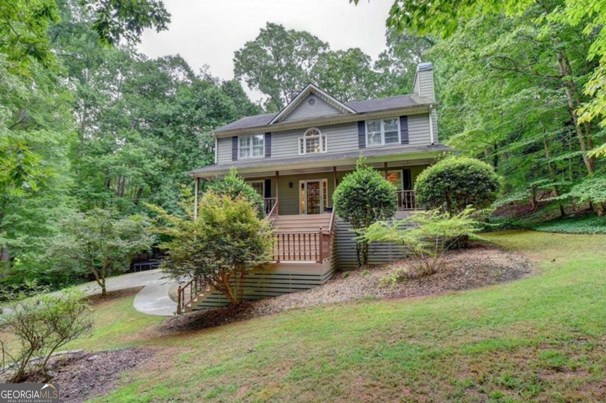 Recently renovated 3 bedroom 2.5 bath home sitting on a 1 acre private wooded lot. Rocking chair front porch, oversized covered back porch, fenced in yard, partial basement for a workshop or recreational toys and two car garage. Beautiful kitchen with quartz counters, stainless steel appliances, island, separate dining area in kitchen and a separate dining room. Family room has a stunning bricked wall with fireplace and rustic mantle. All hardwood floors and tiled baths throughout the entire home, no carpet. Master bath has an oversized shower with river pebble floor, a soaking tub, double quartz vanity and a walk-in closet with custom shelving. Large secondary bedrooms include oversized closets. Custom lighting throughout. Sought after Dean Rusk and Sequoyah school districts.