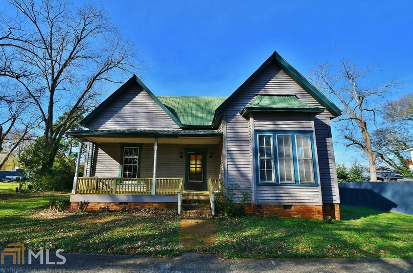 Beautiful older home with lots and lots of character in great city location! Truly a diamond in the rough. 2 or 3 bedroom - It's up to you. Large, level lot within walking distance of downtown Commerce, restaurants, shopping, entertainment and I-85. Great opportunity and a great price! This home is perfect for anyone willing to put a little TLC! Excellent investment opportunity as well.