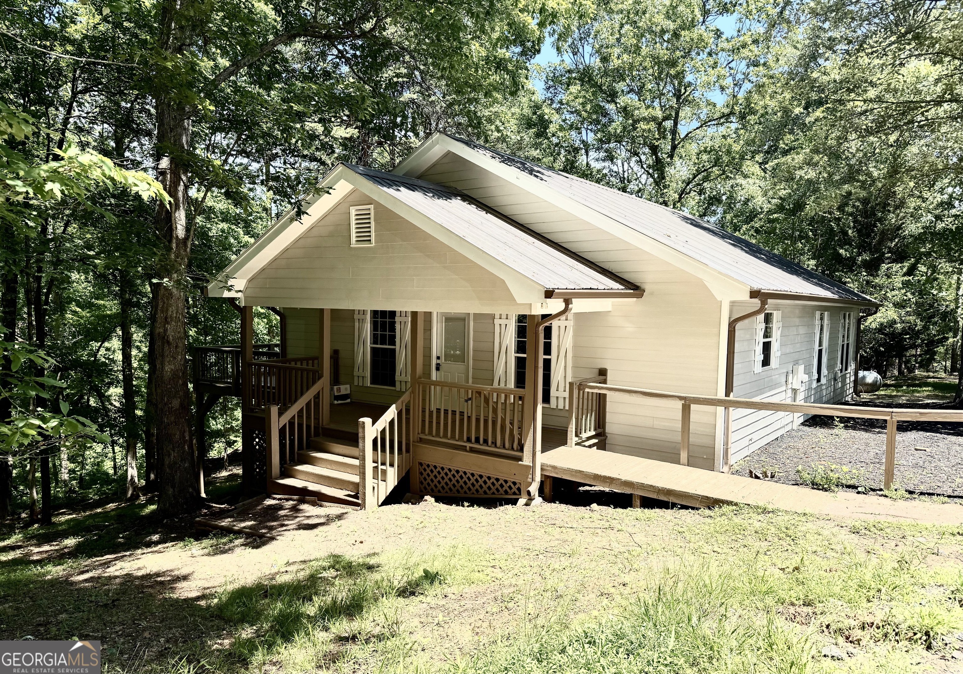 Newly Renovated Modern Home on 1.46 Acres in Highland River Subdivision-Welcome to this beautifully renovated 3-bedroom, 2-bath home nestled on 1.46 acres in the desirable Highland River subdivision. Located a short drive from downtown Dahlonega, local restaurants, shops, and all the charm North Georgia has to offer, this home combines convenience with comfort and style. Step inside to discover a modern open floor plan enhanced by new flooring, contemporary paint colors, stylish lighting, and upgraded plumbing fixtures. The open-concept kitchen is perfect for entertaining, featuring stainless steel appliances and plenty of counter space. The spacious living room is filled with natural light and showcases a cozy electric fireplace set into a custom rock feature wall-ideal for relaxing evenings. The main floor offers three bedrooms, including a serene master suite complete with a walk-in closet, standalone shower, and a luxurious soaking tub. A second full bathroom is perfect for guests or family use. Enjoy outdoor living with a covered rocking chair front porch and an open back deck, perfect for grilling and gatherings. The full unfinished basement offers endless possibilities-create a workshop, bonus room, or additional living space to suit your needs. Whether you're seeking a permanent residence or a peaceful retreat in the mountains, this move-in ready home has it all. Don't miss your opportunity to own a piece of Dahlonega!