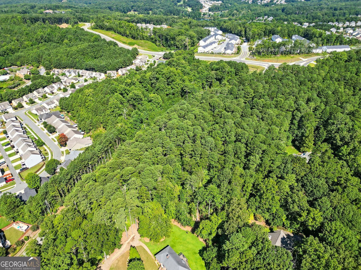 Rare opportunity for investors and developers: 5.69 acres with 489 feet of road frontage, strategically located near Fate Conn Road & Heard Rd just off the new major roundabout. This tract is positioned on the edge of Canton's Future Development Corridor and sits in the heart of a rapidly growing area surrounded by successful residential communities including Towne Mill & Hickory Bluffs. The property offers access to all utilities, with a current survey on file, making it ideal for a variety of development possibilities. Public sewer is approx. 250' from the property. Its close proximity to the Hickory Log Creek Reservoir boat launch (approx. 1 mile away) adds lifestyle appeal, while access to I-575, retail, dining, and daily conveniences ensures both connectivity and long-term growth potential. This is a prime development opportunity in one of Canton's most desirable and fast-developing corridors.