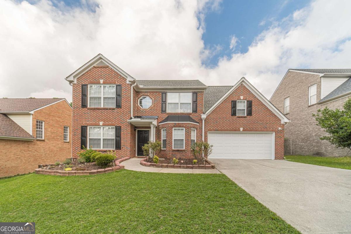 Welcome home to this move-in ready, 4-bedroom, 2.5 bathroom, 3-sided brick beauty! Upon entry you will see a formal living/flex room on the left and separate dining room with bay window on the right that flows into the bright kitchen with 42" white cabinets, granite countertops, subway tile backsplash, smooth top stainless-steel range, stainless-steel refrigerator, built-in stainless-steel microwave, breakfast bar, pantry and eat-in area and is completely open to a spacious family room with marble surround auto-start fireplace. The half bath and laundry room completes the main floor. Rear staircase takes you upstairs to the primary suite with deep tray ceiling, sitting area, walk-in closet, double sink vanity, garden tub, and separate shower. Bedrooms 2, 3 & 4 are spacious, have ample closets and share a full tiled bath and linen closet. Great outdoor space includes patio and private yard. NEW ROOF! Top of the line, large load LG Thinq stainless-steel washer & dryer included with the purchase of the home. This home is located in a community with great amenities including a pool, playground, and sidewalks. Schedule your tour today!