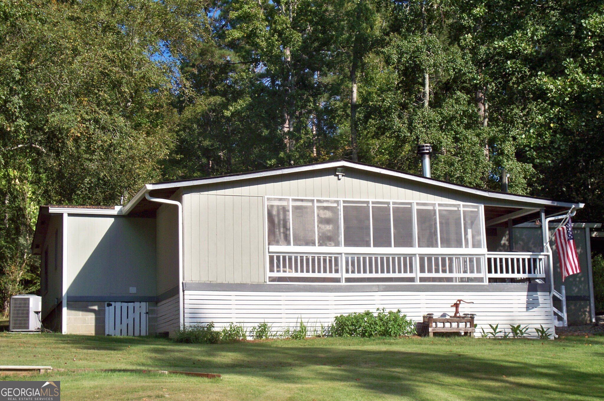 Be on Lake Sinclair for less! 3BR/2BA Manufactured Home nestled on a private 1.8 Acre lake front paradise. Recently Remodeled with an Open Concept Kitchen & Great Room w/Beam Ceilings & Large Fireplace for those cozy nights by the fire. This well appointed lake front home boasts a formal dining room, spacious primary bedroom w/walk in closet. Full length front porch & Large Screened in Lakeside porch w/separate grilling area. Roof & AC replaced in 2017. The level 1.8 acre lot offers a Double Boat House w/lift, full size dock & 150' of seawall. In Addition to the resurfaced driveway there is plenty of storage in your 12' x 20' storage building, 8' x 10' storage building & 30 amp RV hook-up. All the appliances come with the sale including the washer & dryer. Don't let this one get away from you at $279,000
