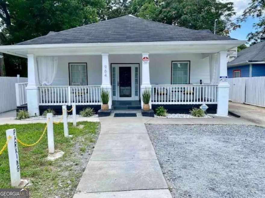 A beautifully updated 4-bedroom, 2-bath single-family residence featuring 2,304 SF of living space on a nearly 0.2-acre lot in the J.E. Hughes neighborhood of Northwest Atlanta. Built in 1925 and recently remodeled, this home offers spacious interiors with high ceilings, hardwood floors, walk-in closets, and modern finishes throughout. The layout includes a master suite on the main level and an open concept kitchen and living area. Outdoor living is enhanced by a covered front porch with ceiling fans and swing chairs and a large backyard deck, currently have a long-term tenant in place. With ample parking (2-3 spaces in front, 4-6 in back), it's a rare find in this area. The property is ideally located near Mercedes-Benz Stadium, Georgia State University, Morehouse, Spelman, and Clark Atlanta, providing easy access to major employment and educational hubs - a proven driver of rental demand.