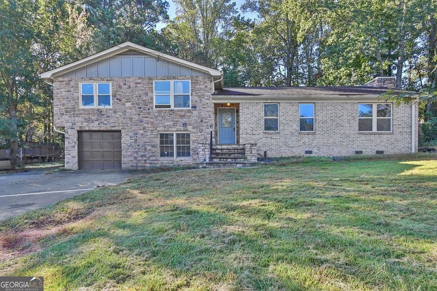 *Check back soon for more photos* Get ready to call this house your next home or investment property! This split-level home is located in a community with no HOA or rental restrictions. The main level features tile and hardwood flooring paired with stone accent walls. The kitchen, dining/living room, and family room are all located on the main level. The eat-in kitchen has sprawling stone countertops w/ breakfast bar, a stainless steel dishwasher, plenty of cabinet space, and tile flooring. Upstairs details all bedrooms and full bathrooms. The primary suite has its own full bathroom. The basement boasts a large bonus room that can act as a bedroom, an additional room, and a laundry room. The fenced backyard has an in-ground pool, a large covered patio, and a storage shed. Close to shopping, dining, recreation, and Woodstock ES, MS, and HS. Seller is open to blind offers, so get your offer in today!