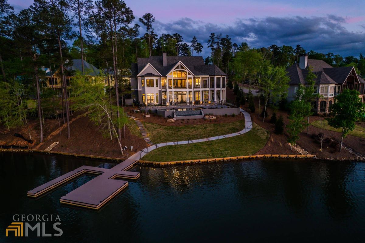 New Custom Home in Reynolds Lake Oconee is Exceptional with Luxury Finishes Throughout and has Stunning Lake Views. Offering 6800+ sqft. with 6 Bedrooms, 6 Full Baths, 2 Half Baths, Infinity Pool, Home Theater & Elevator. , Soaring Ceilings, Walls of Windows, Designer Lighting & Fixtures, Wolf & Sub Zero Appliances, Coffee Station, Custom Cabinetry, Quartzite Tops, Master On Main, Fantastic In-Door/Out-Door Entertaining Areas, Max Dock. Full Golf Membership Available. Home Warranty Provided