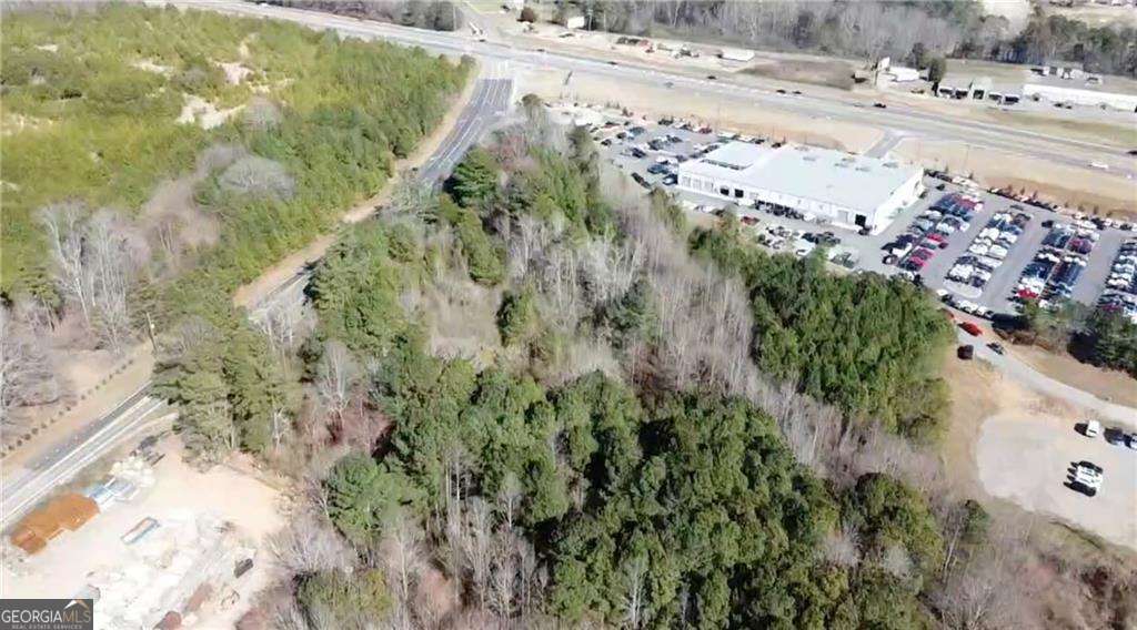 Great location! 7.38 acre property already zoned CBD - Commercial Business District with over 750 ft of frontage on Hubbard Town Road and within view of the intersection of Ga Hwy 400 (US 19) & Hubbard Town Rd. Intersection has traffic light and turn lanes with over 37,300 avg daily traffic count on Ga Hwy 400 according to GADOT. Property adjoins site of Don Jackson's auto dealership and CAT. Sanitary sewer located on site. Forsyth County water main located on north side of Hubbard Town Rd.